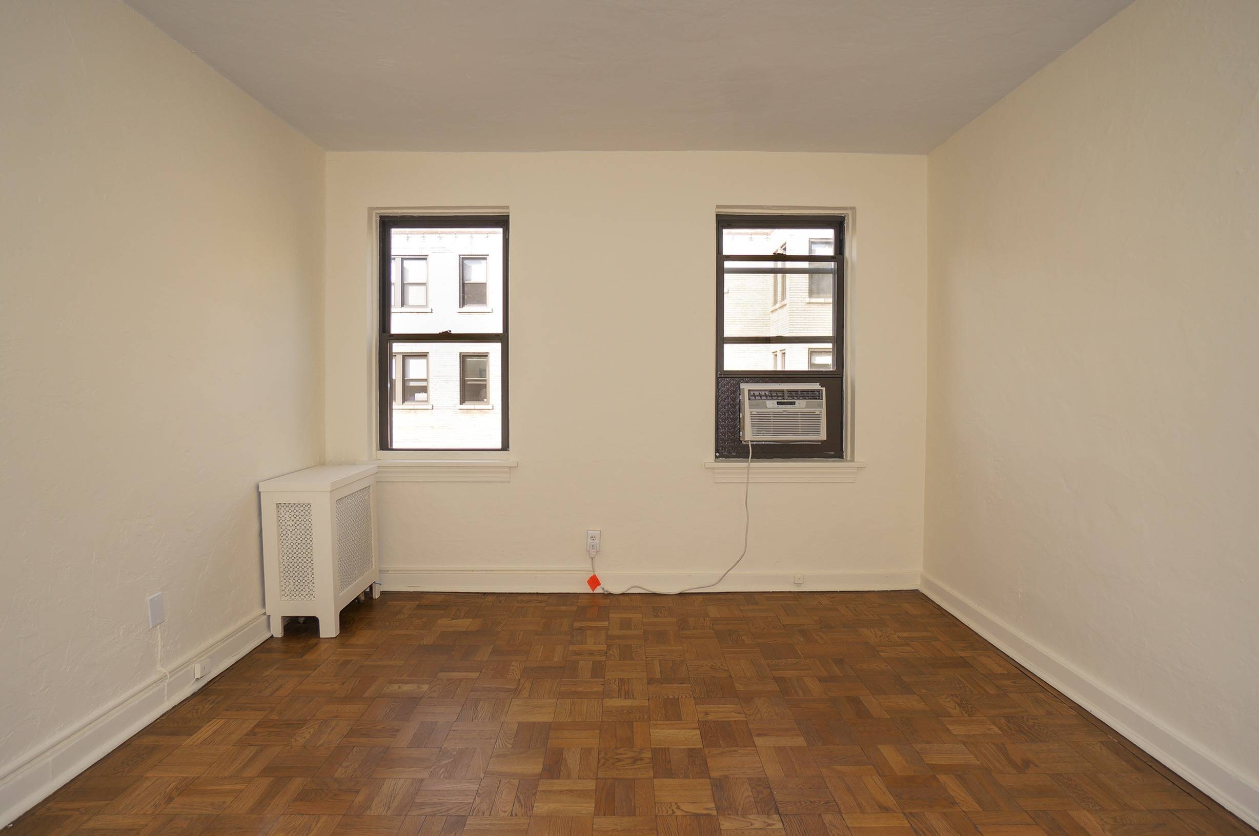 Bedroom shows windows and Air Conditioner