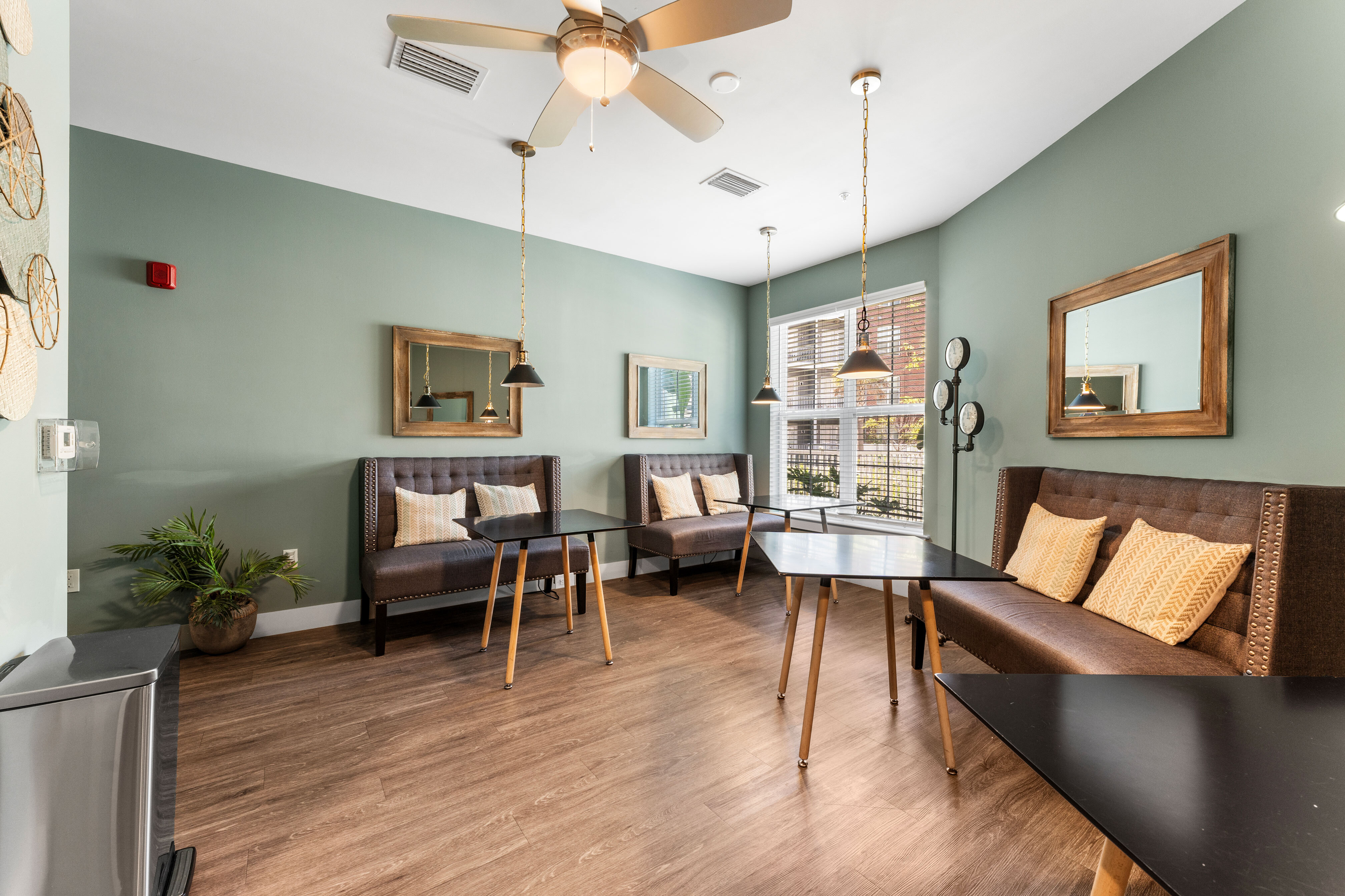 Inviting communal area with stylish seating, modern lighting, and large windows providing natural light.