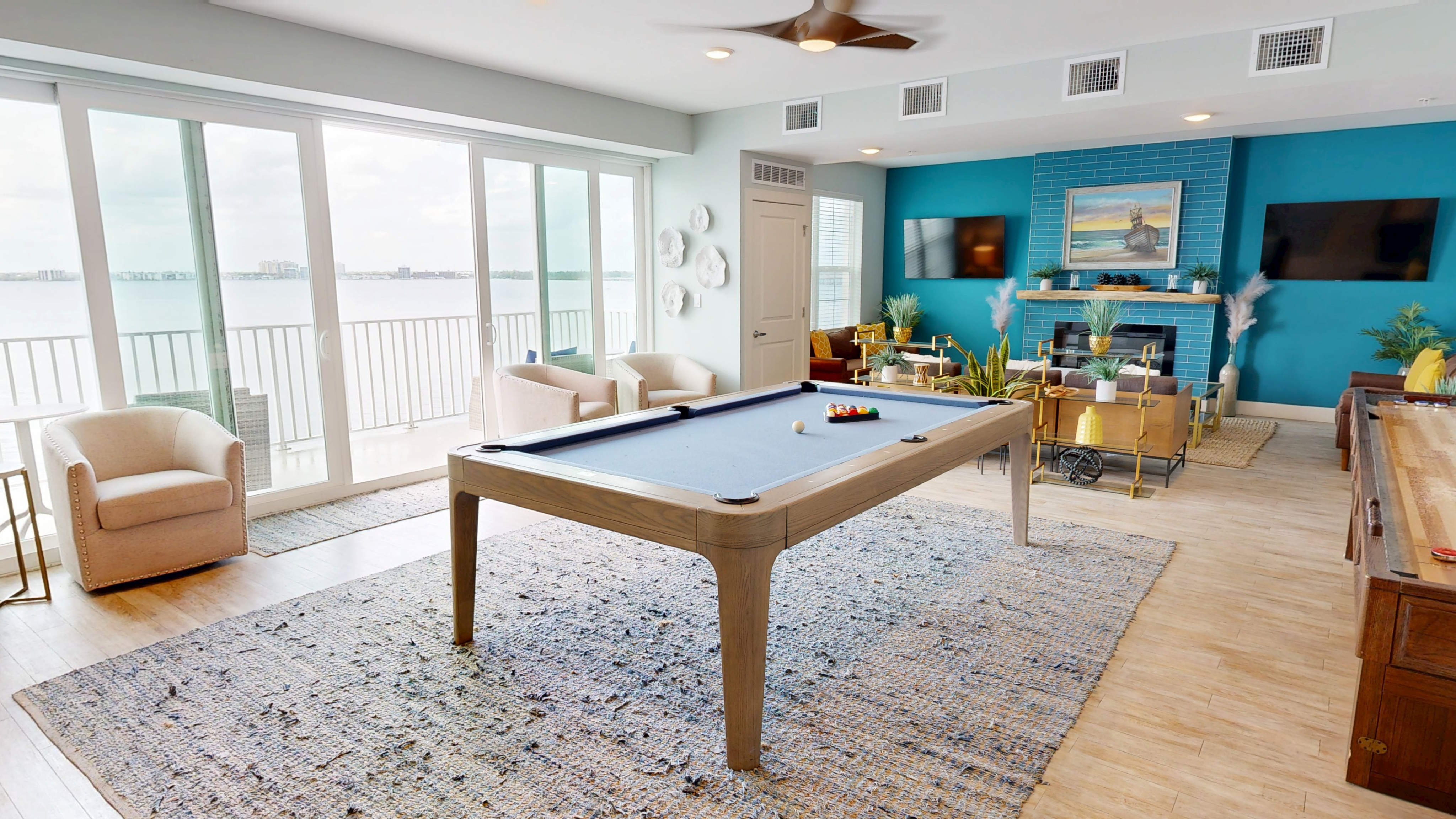 LTriton Cay Fort Myers 5th Floor Lagoon Loungeuxurious entertainment room with pool table, ocean view, and stylish decor, perfect for relaxation and gatherings.