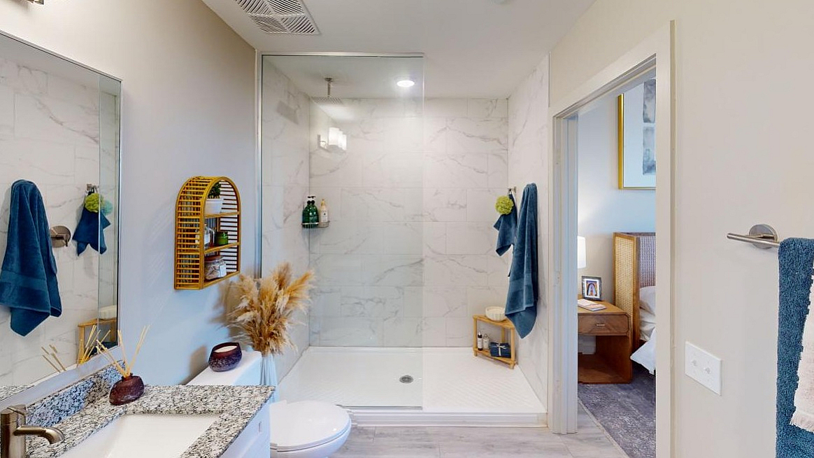 Sophisticated bathroom design featuring a sleek glass shower, elegant marble tiles, and modern decor for a luxurious experience.