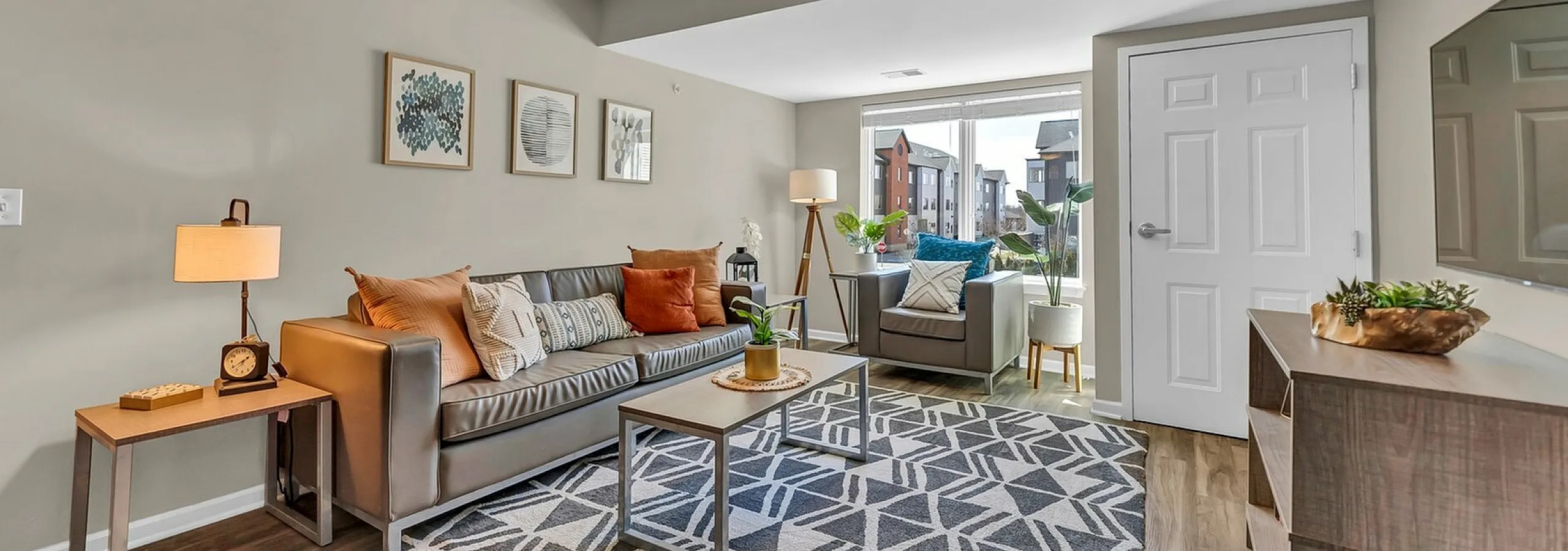 Bright and inviting living room with contemporary decor, plush seating, and large windows offering scenic views.