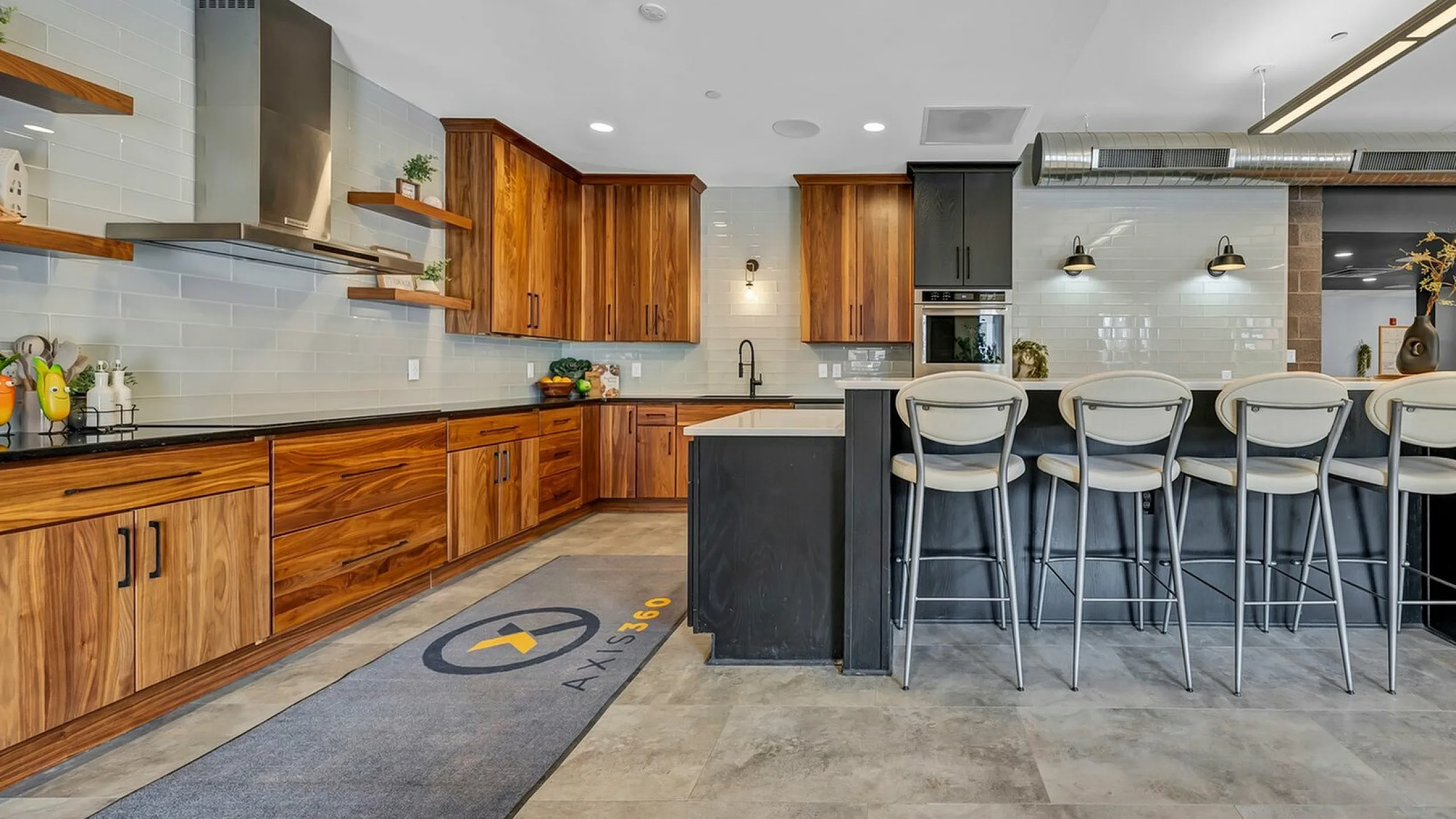 Modern gourmet kitchen with sleek wooden cabinets, elegant bar seating, and stylish industrial accents designed for luxury living.