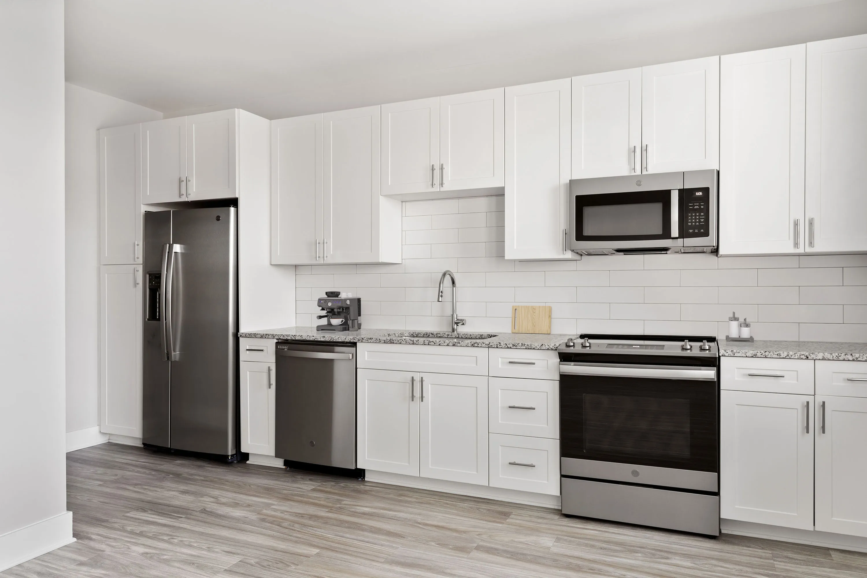 Model kitchen with stainless appliances at Chestnut Farm Apartments in Matthews NC