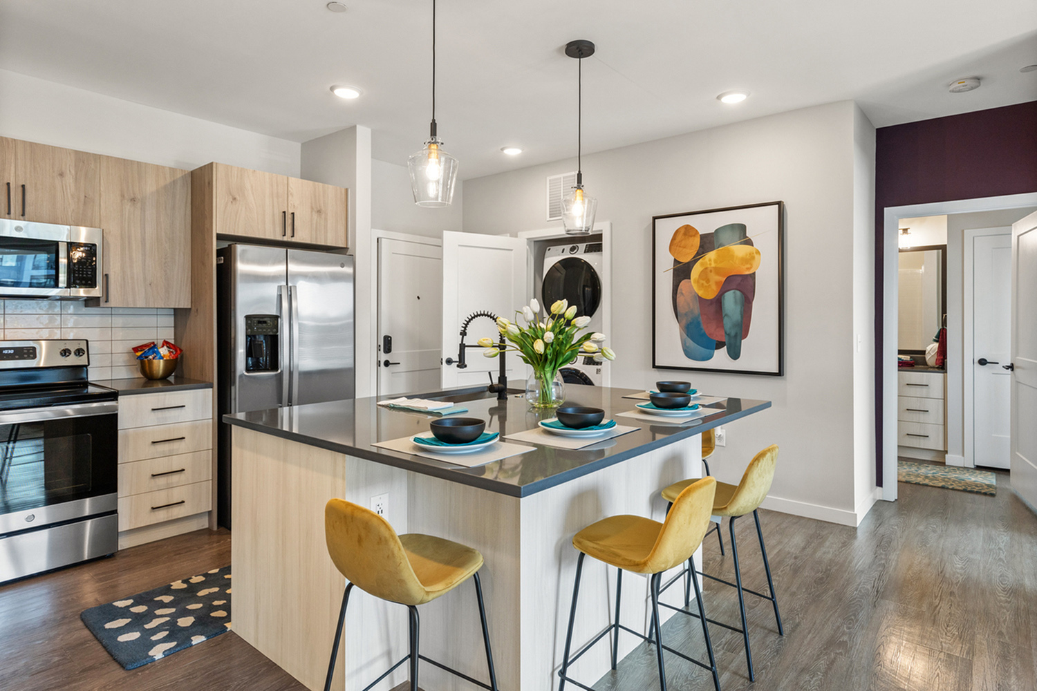 Modern kitchen with sleek appliances, elegant island with seating, and stylish decor.