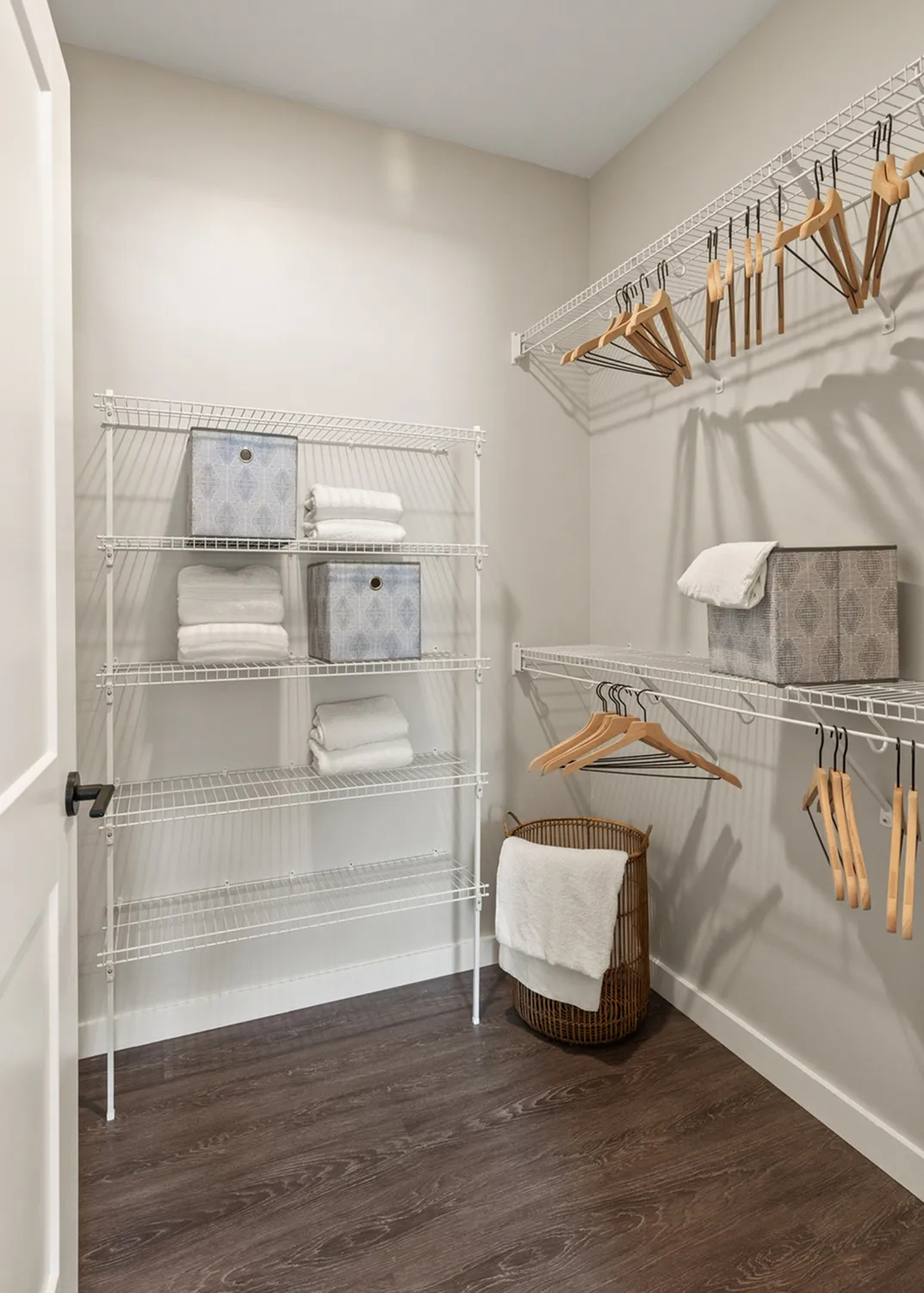 Organized walk-in closet with wire shelving and ample storage space.