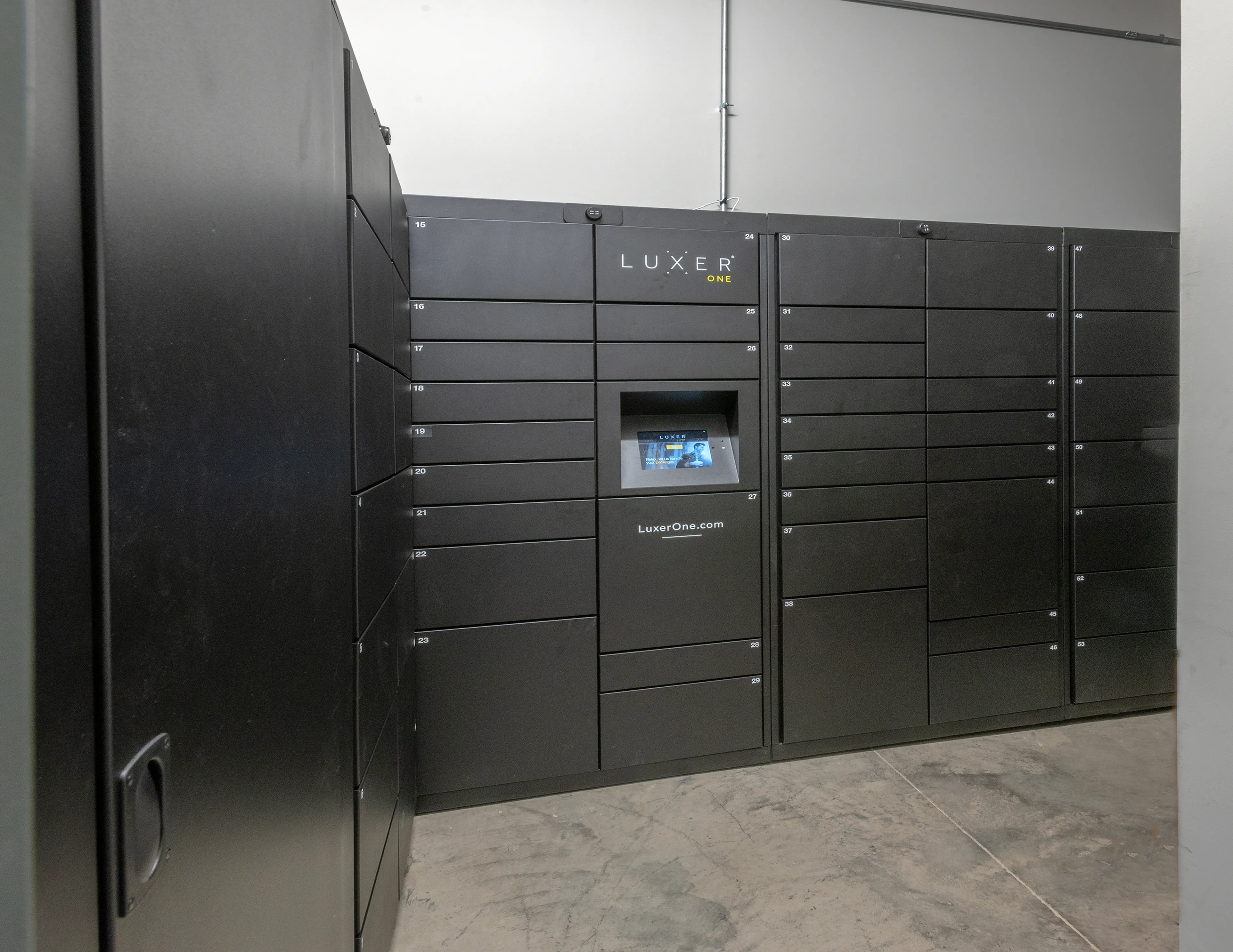 Modern package locker system in sleek black with electronic interface, ensuring secure and convenient parcel storage.