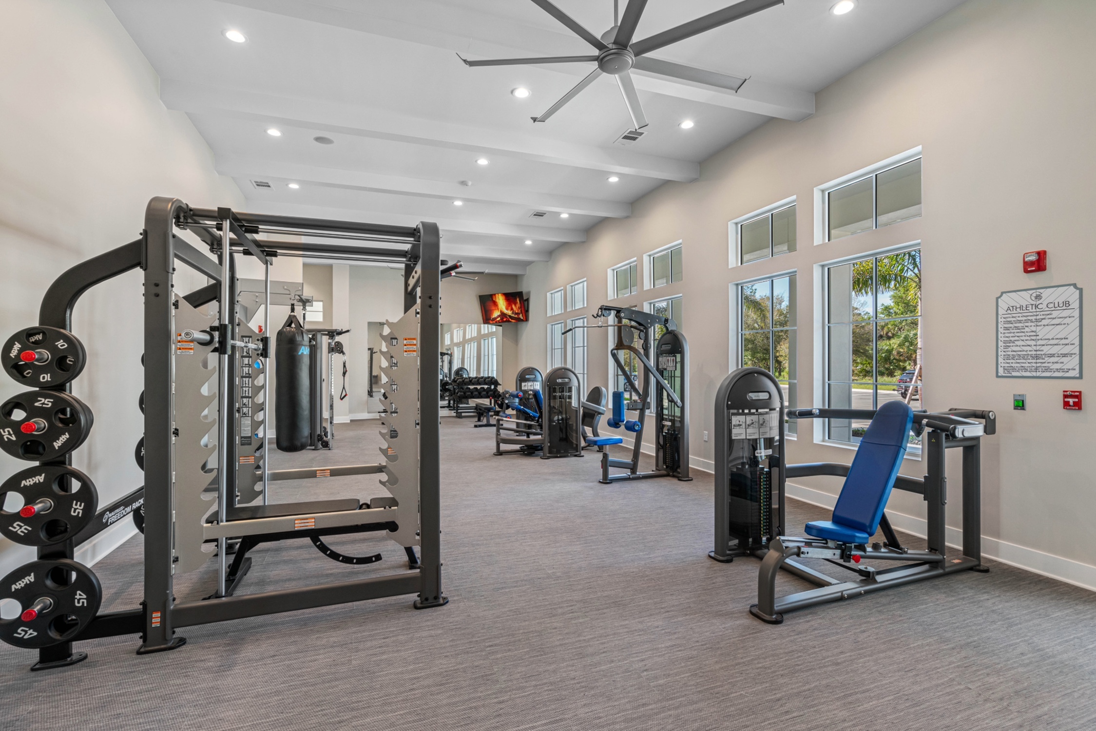 Spacious and modern fitness center equipped with top-of-the-line workout machines and bright natural lighting.