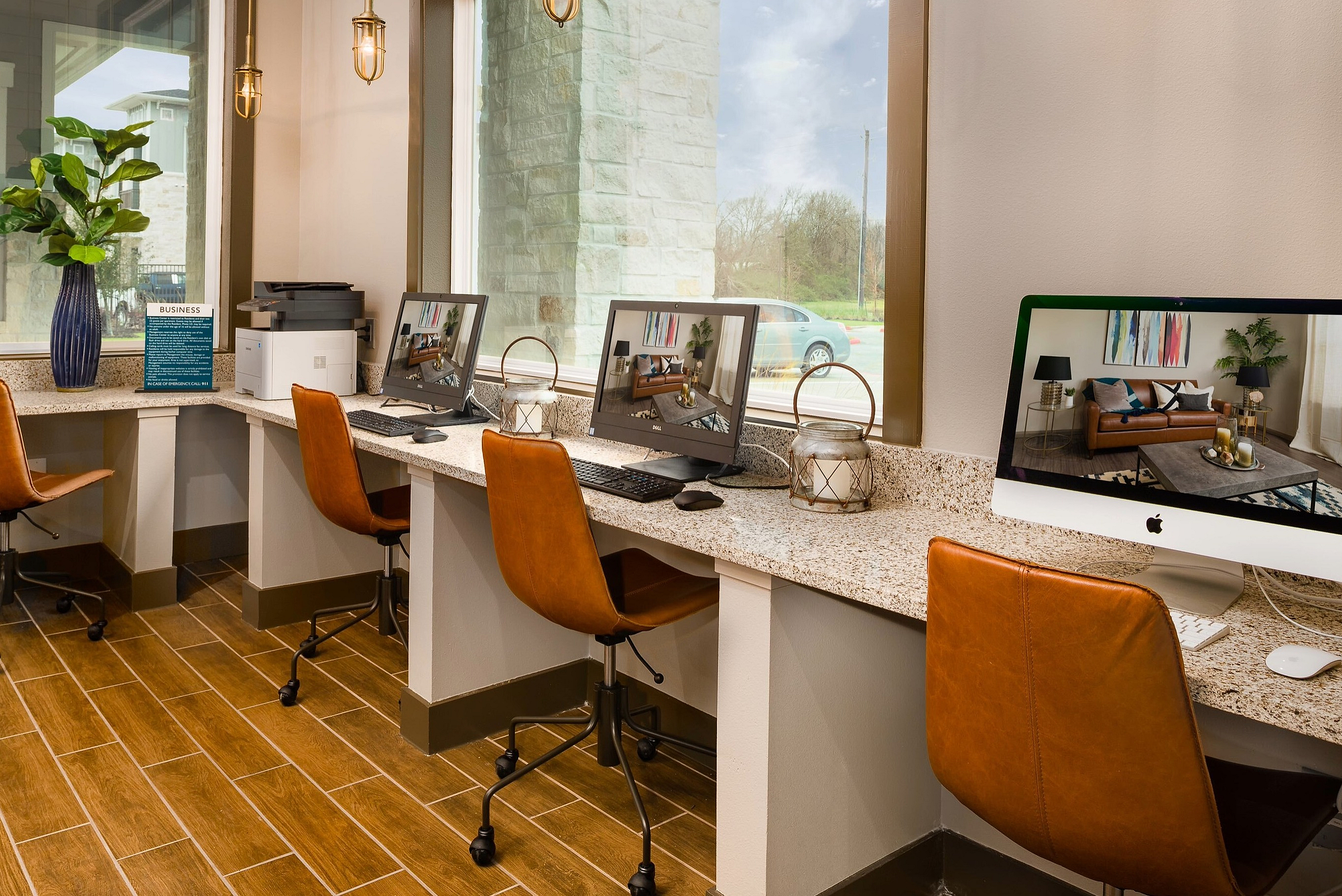 Modern co-working space with warm lighting, sleek countertops, and leather chairs, offering a comfortable and stylish work environment.