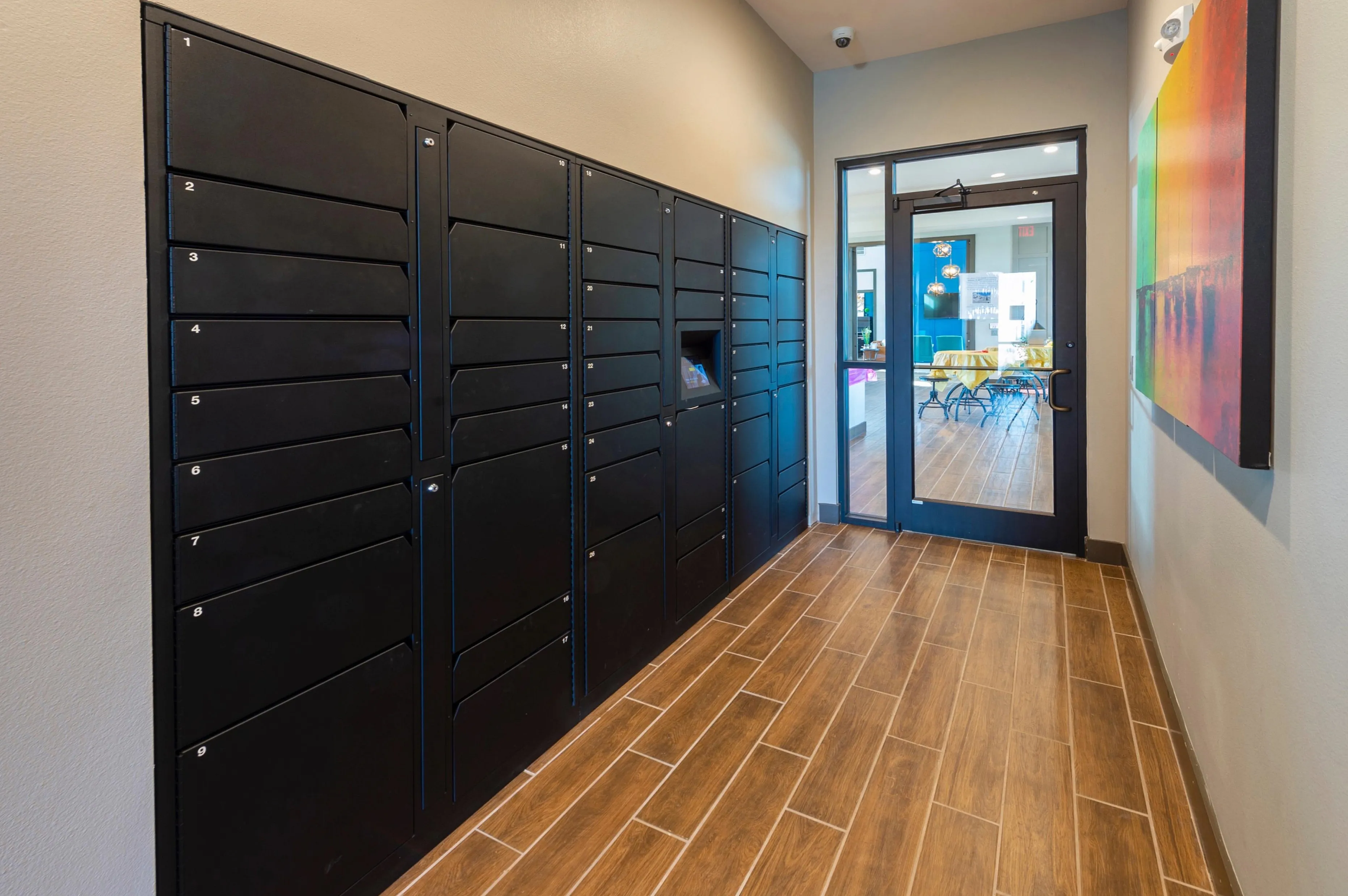 Chic apartment package locker area with modern design and vibrant artwork.