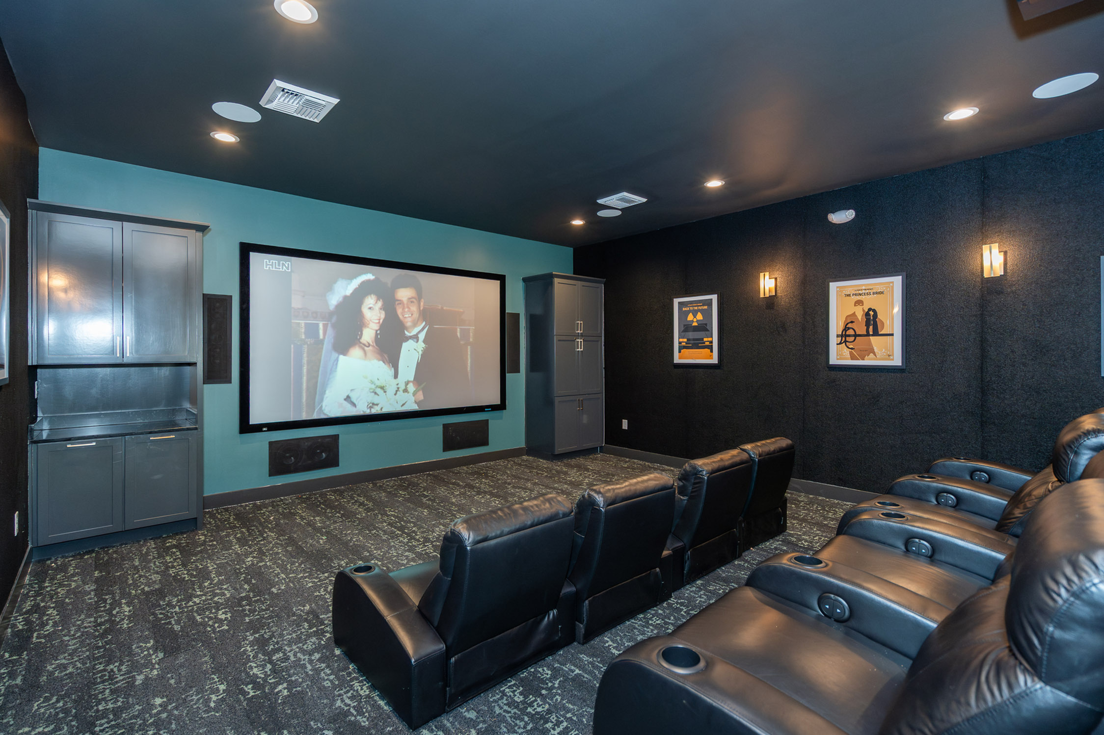 Luxurious home theater with plush leather seating, ambient lighting, and a large screen for an ultimate cinematic experience.