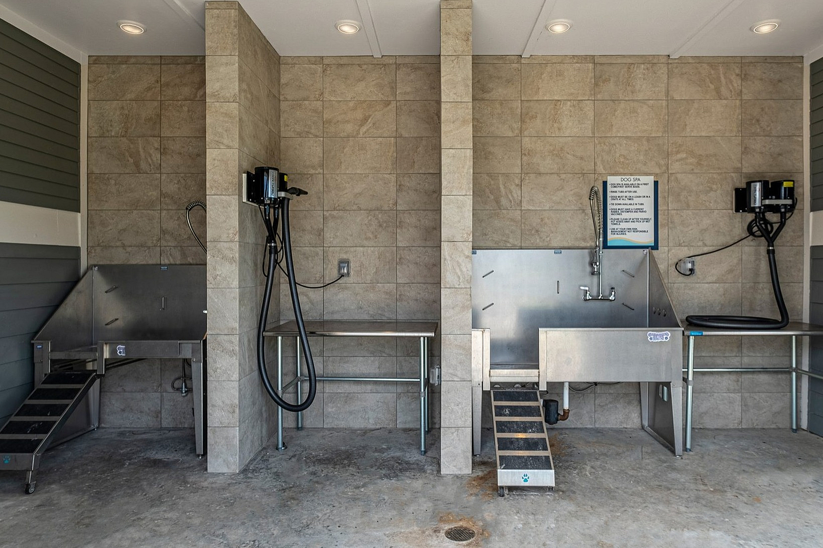 Modern apartment pet spa with sleek stainless steel wash stations and premium amenities, offering convenience and style for pet owners.