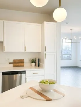 Cortona remodeled kitchen with white cabinets and gold fixtures