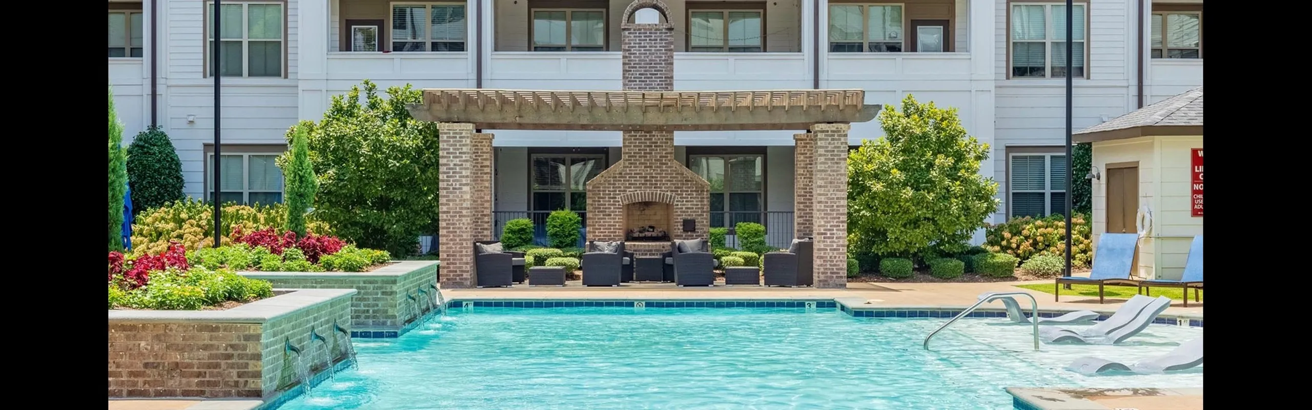 Resort-Style Pool with Expansive Sundeck and Outdoor Living Room at RiverHouse Apartments in Little Rock, AR