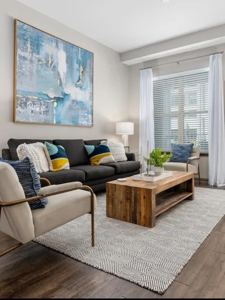 Open Living Room with Wood-Designed Flooring at Riverhouse Apartments in Little Rock, AR