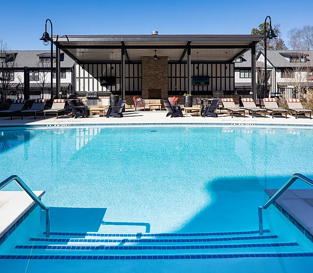 Inviting outdoor pool area with sun loungers and modern amenities, offering a tranquil escape.