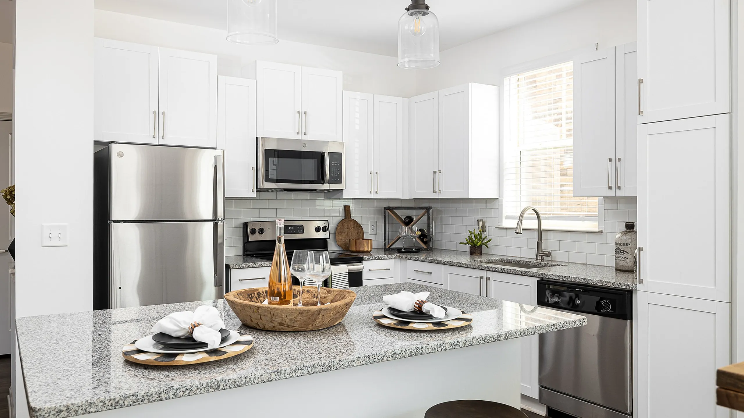 Contemporary kitchen with modern appliances and stylish white cabinetry.