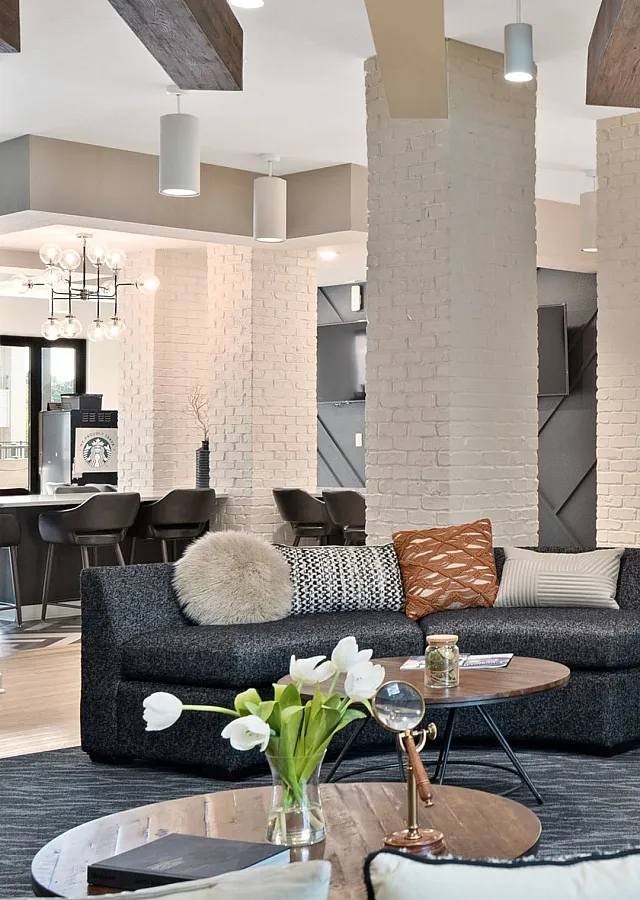 Stylish community lounge featuring modern furniture, ambient lighting, and a welcoming atmosphere.
