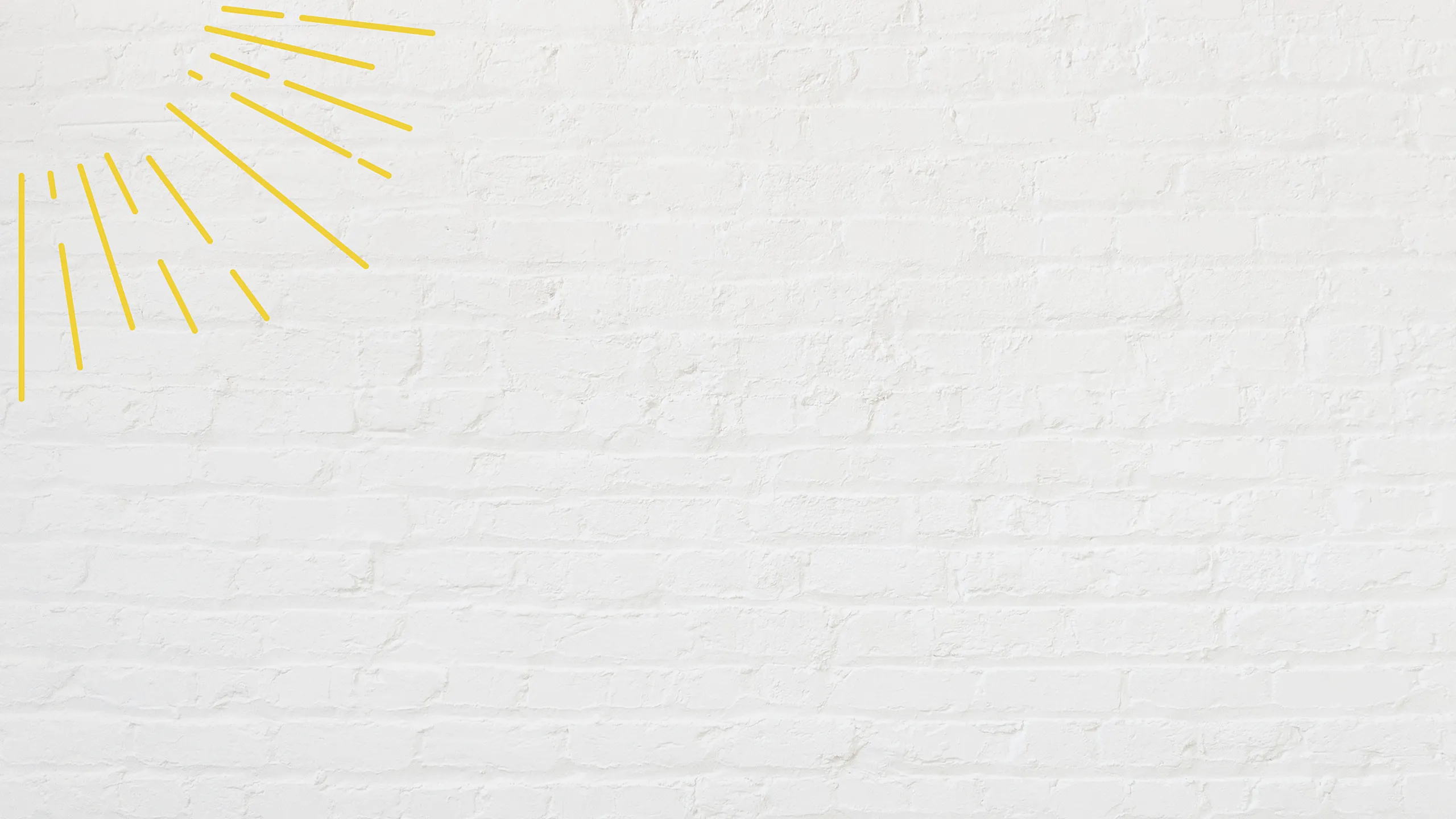 White brick wall with artistic yellow lines resembling sun rays.