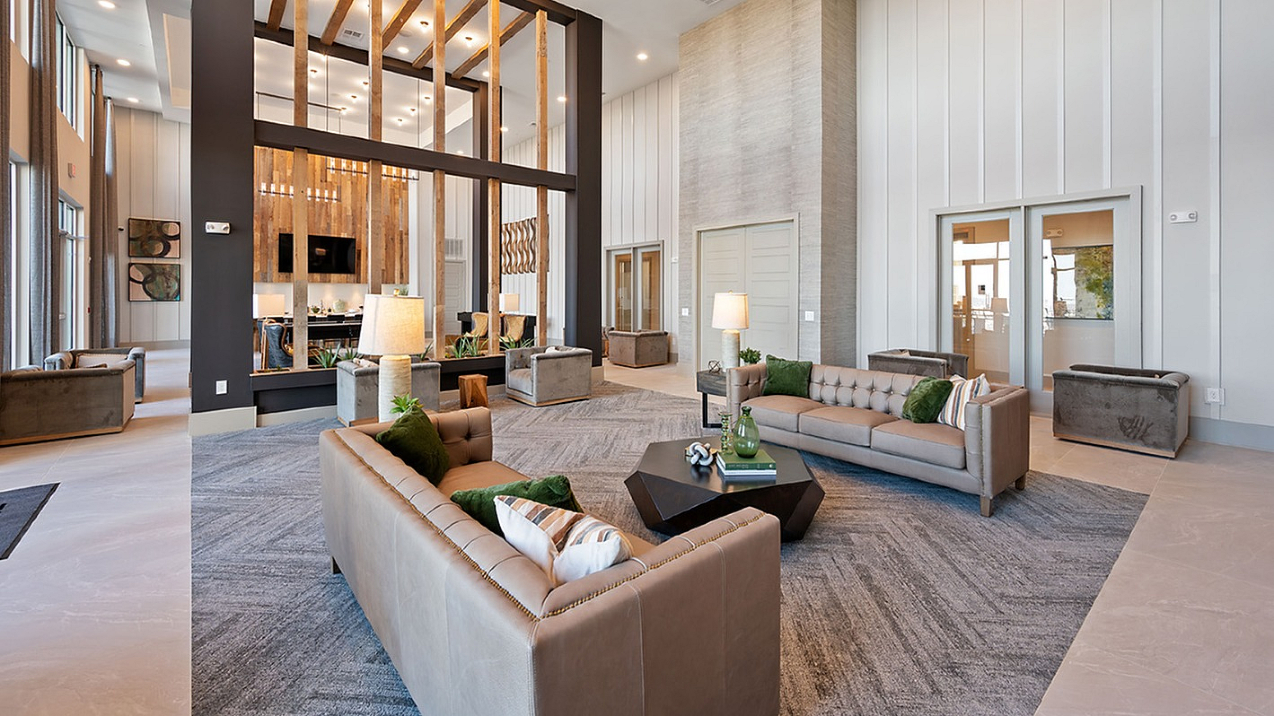 Elegant and spacious lounge area featuring modern sofas, stylish lighting, and a unique wood-paneled design.