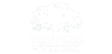Elegant logo of Grand Oaks at Crane Creek featuring a majestic oak tree silhouette.