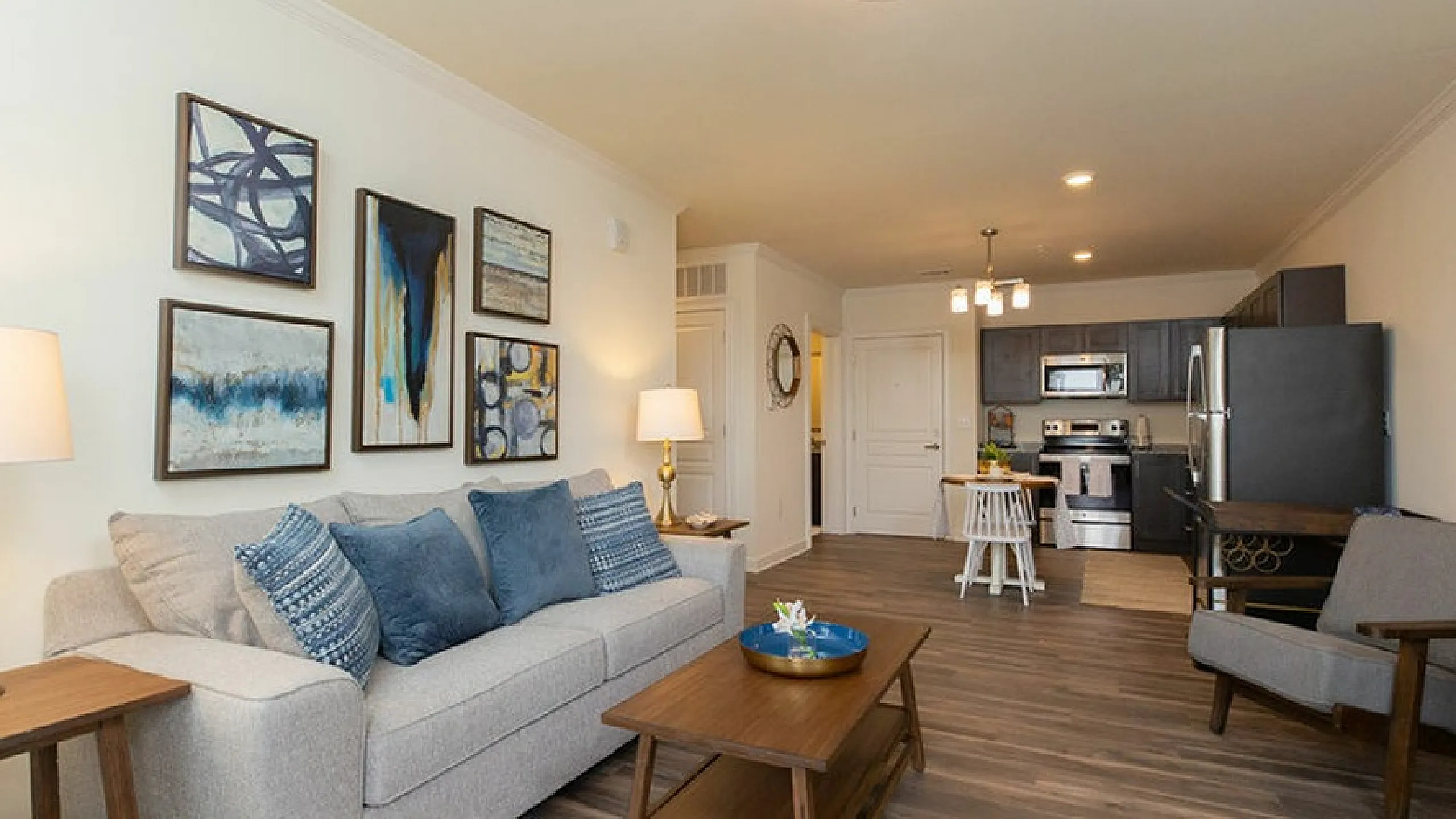 Elegant open-concept living space with modern kitchen, stylish decor, and cozy seating area, perfect for relaxation.