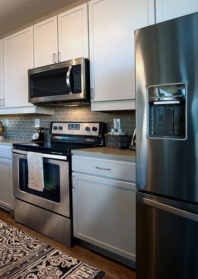 Modern kitchen with stainless steel appliances, elegant cabinetry, and stylish backsplash for a sleek finish.