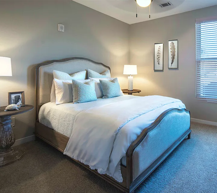 Inviting bedroom with elegant decor, featuring a plush bed, stylish side tables, and soft ambient lighting.