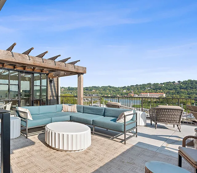 Chic outdoor terrace with modern seating, pergola, and scenic views, perfect for relaxation and entertaining.