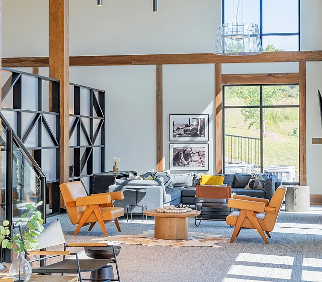 Bright and inviting living room with modern design, large windows, and cozy seating, perfect for relaxation and entertaining.