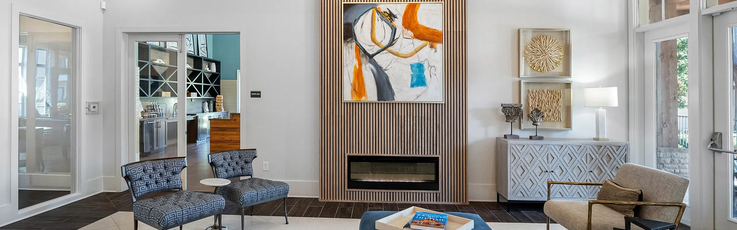 Elegant living room with modern decor, featuring a sleek fireplace, stylish artwork, and cozy seating.