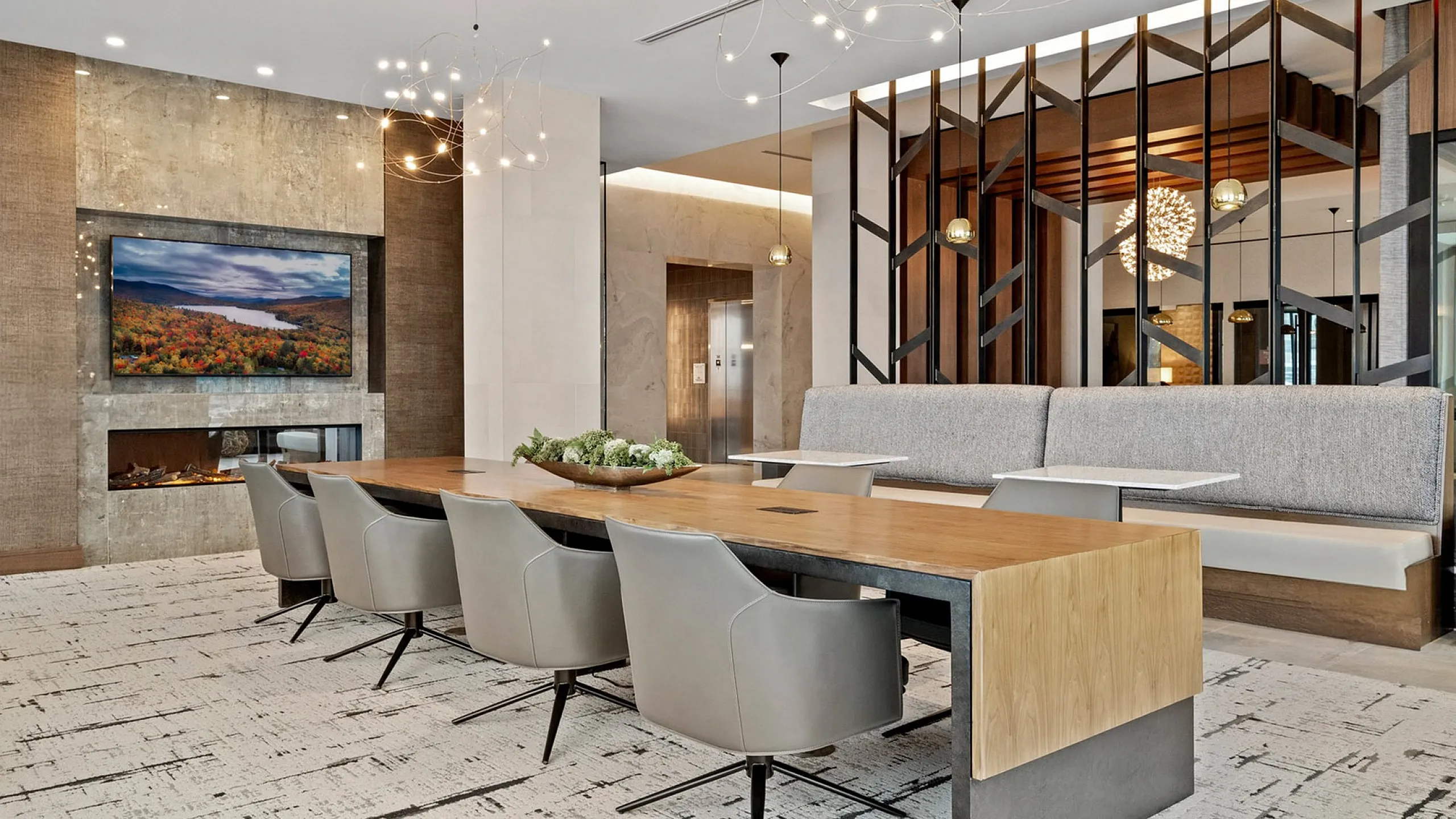 Elegant and modern communal dining area with chic seating, stylish decor, and ambient lighting perfect for gatherings.