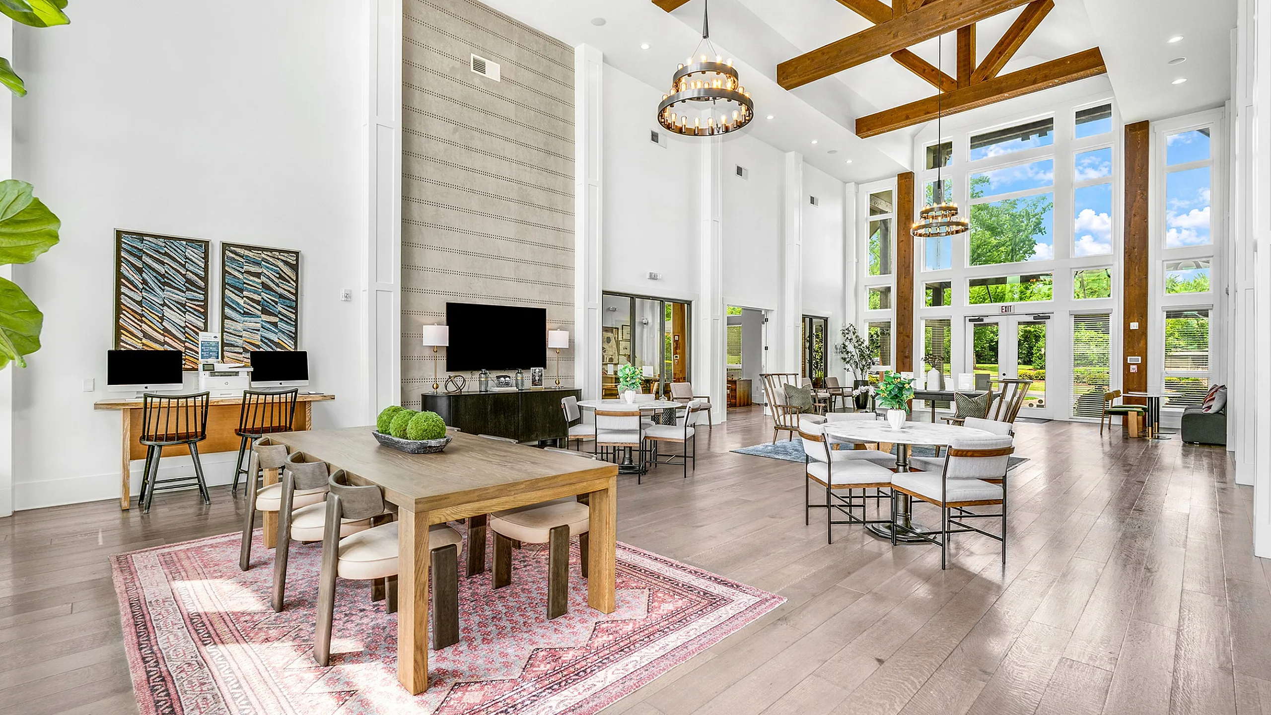 Luxurious open-concept lounge with vaulted ceilings, elegant dining areas, and vibrant natural light through floor-to-ceiling windows.