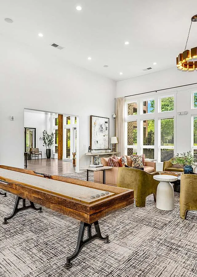 Inviting luxury living room with modern decor, plush seating, and expansive windows offering natural light and scenic views.