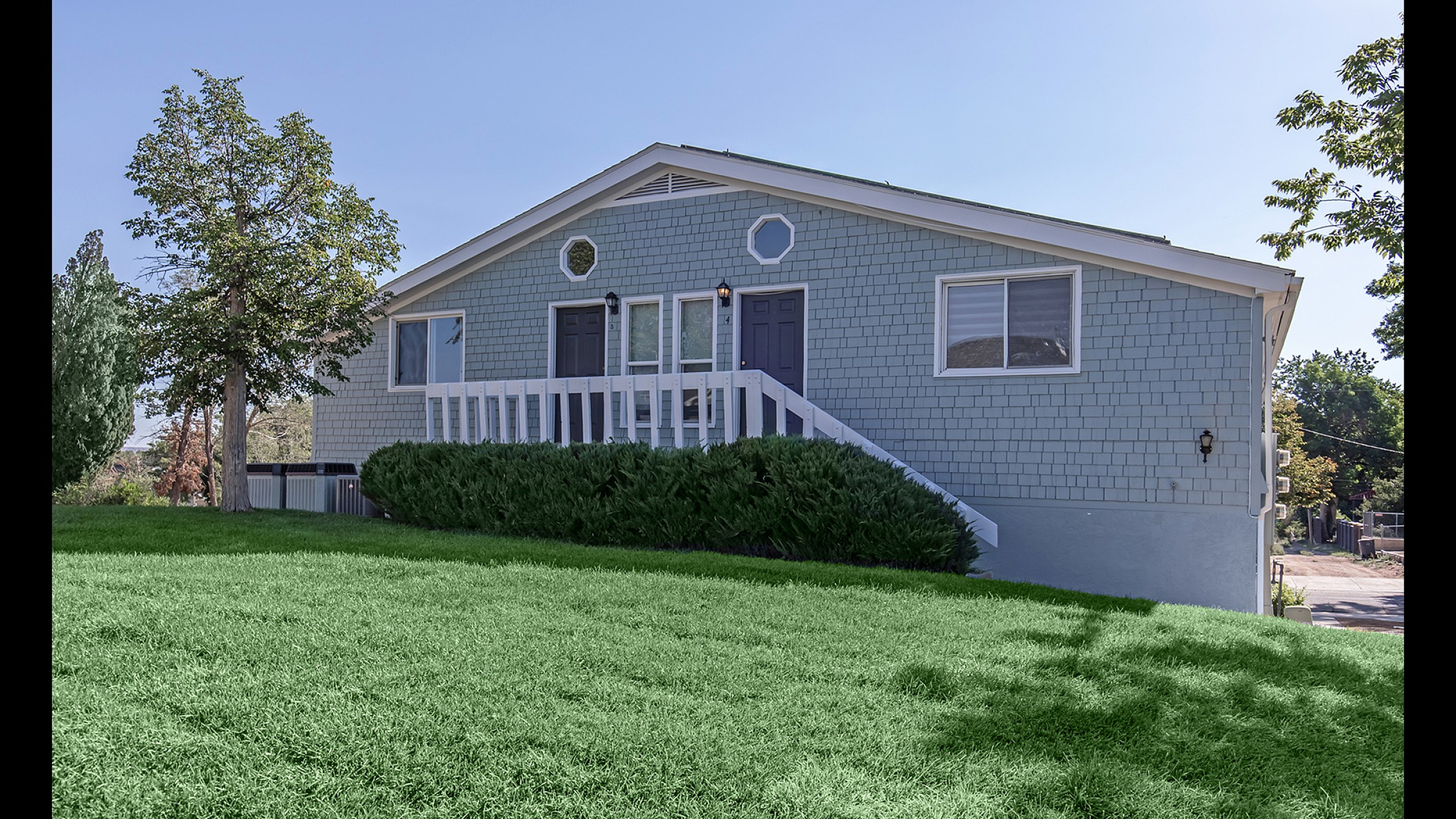 Charming bungalow with a beautiful front lawn and inviting entrance set in a tranquil neighborhood.