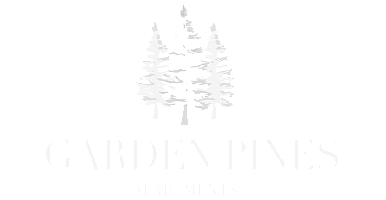 Elegant Garden Pines Apartments logo featuring white pine trees against a sleek black background.