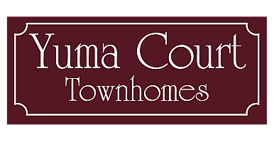 Elegant maroon and white sign for Yuma Court Townhomes, showcasing refined urban living.