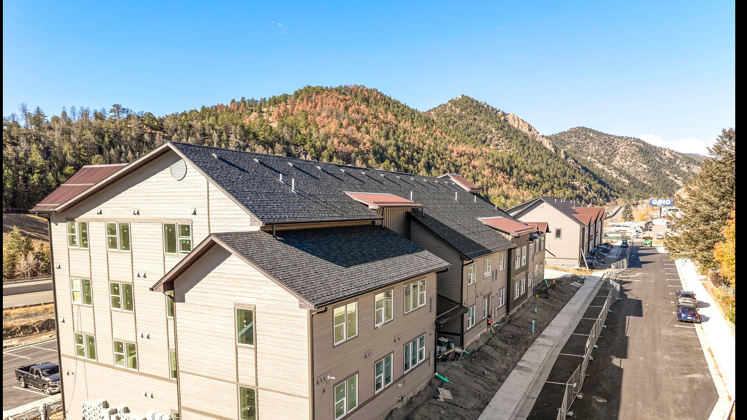 Elegant row of newly constructed townhomes nestled in a picturesque mountain setting, with scenic views and modern architecture.