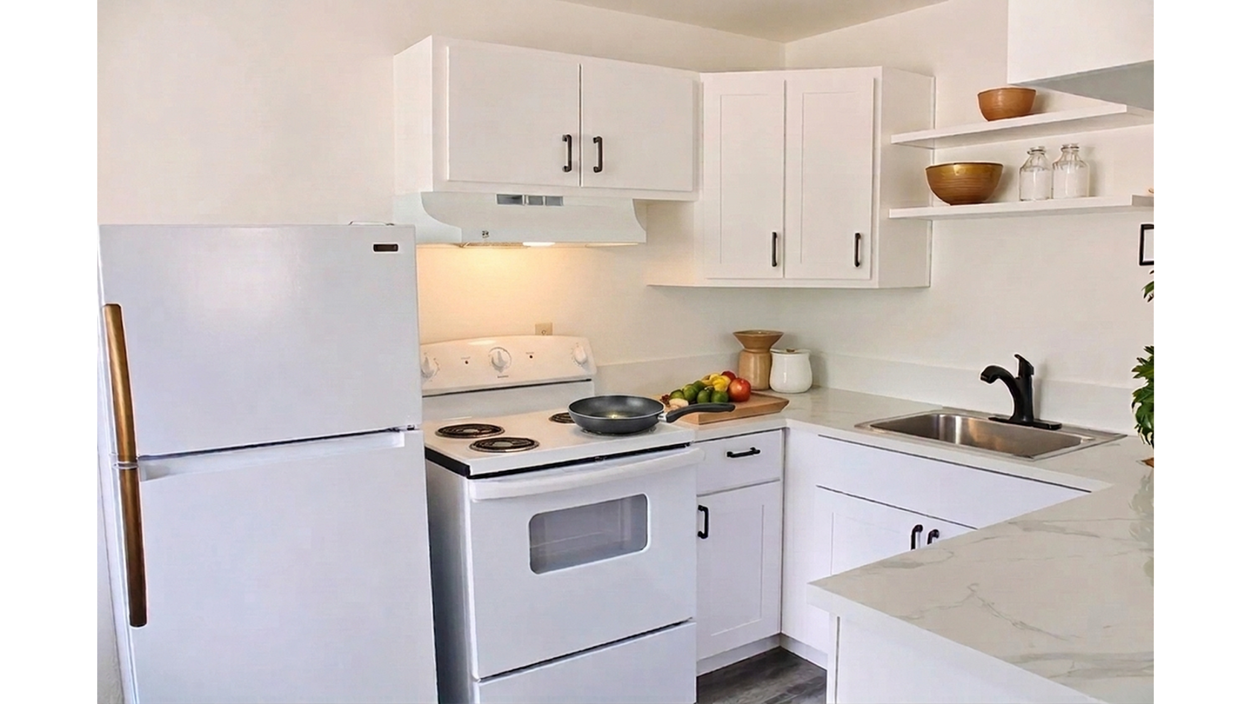 Modern kitchen with sleek white cabinets, marble countertops, and vibrant decor accents creating a fresh and inviting space.
