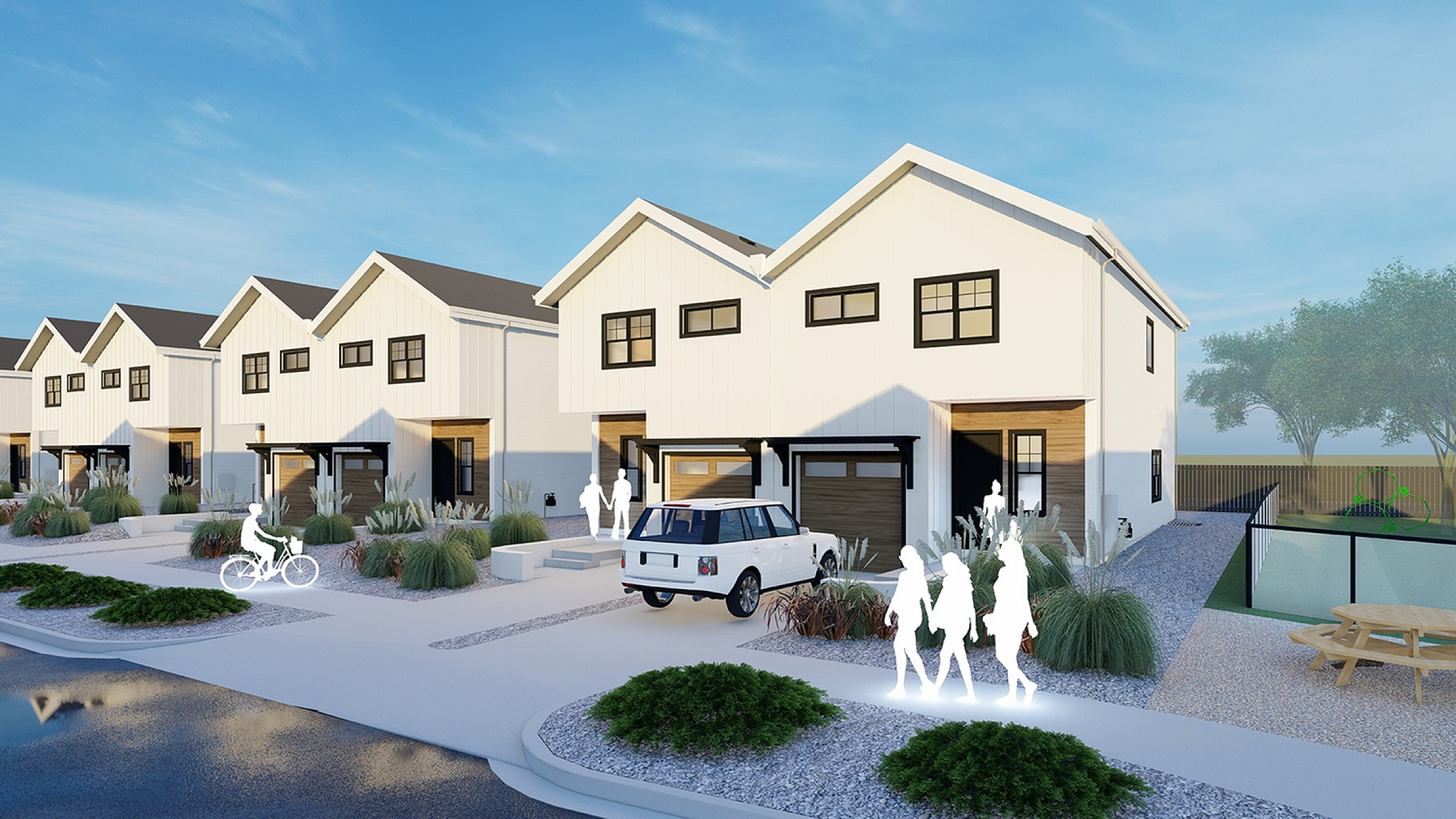 Modern townhouse exterior with sleek design, featuring a welcoming driveway, lush landscaping, and bright, open pathways under a clear blue sky.