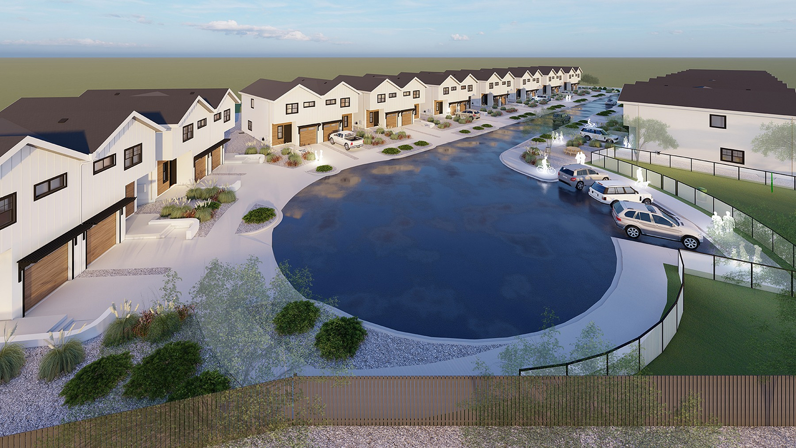 Charming residential development featuring modern townhouses with sleek exteriors, a scenic pond, and lush landscaping.