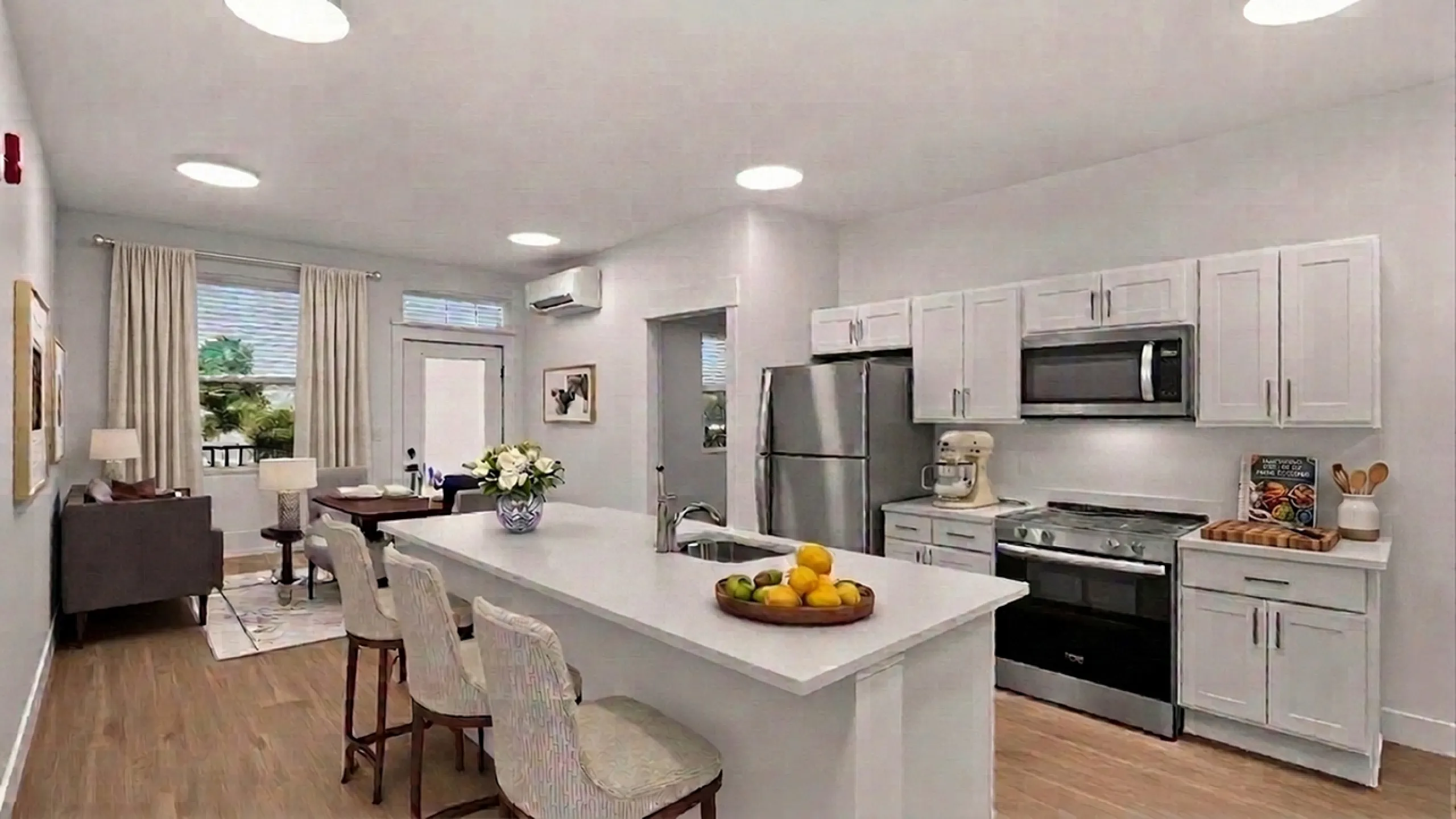 Bright, modern open-concept kitchen and living area with sleek appliances, elegant island, and cozy dining space.