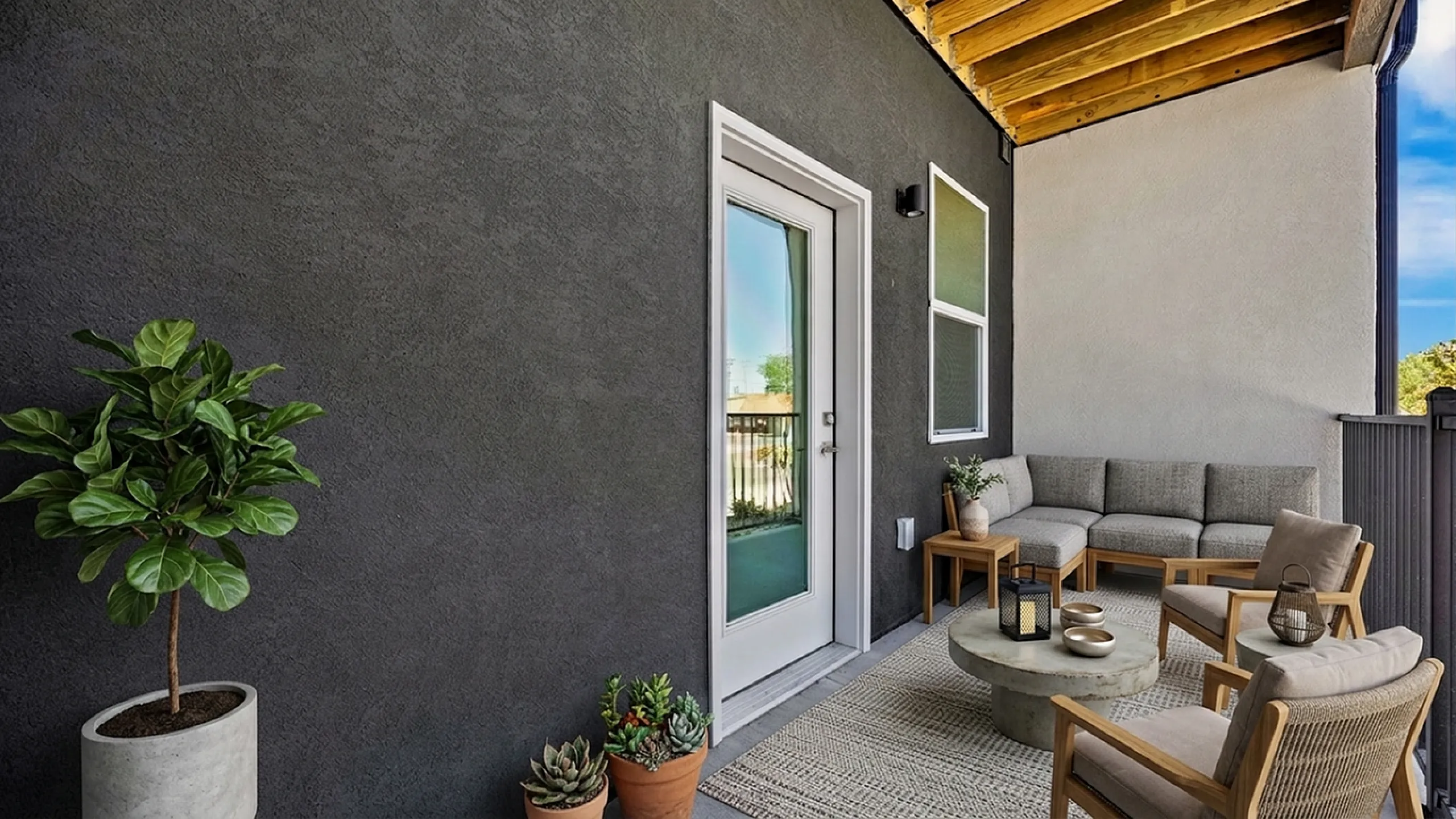 Inviting outdoor patio with stylish seating, lush greenery, and a cozy atmosphere, perfect for relaxing and entertaining.