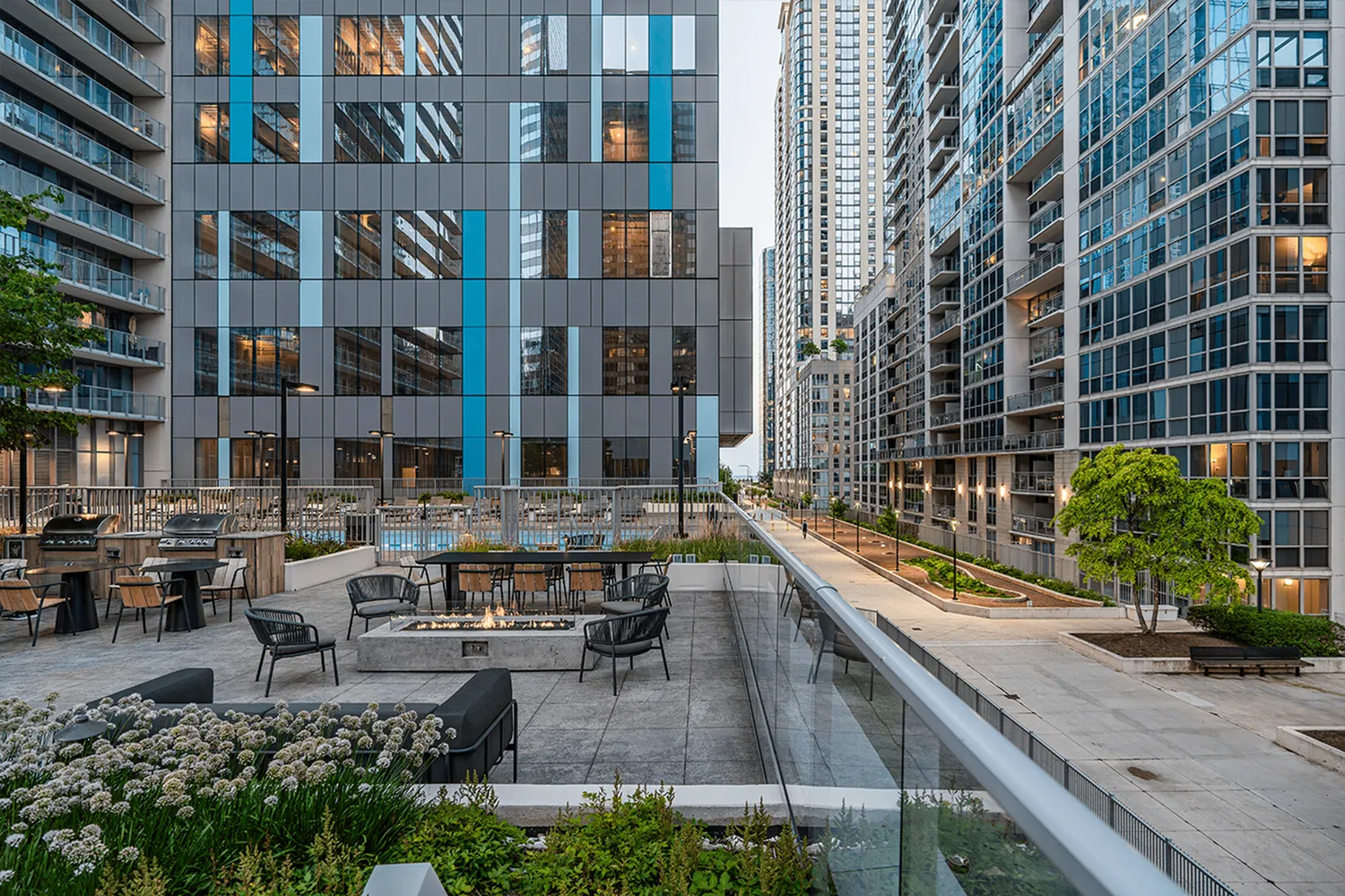 Stunning urban apartment complex with modern architecture and outdoor seating area.