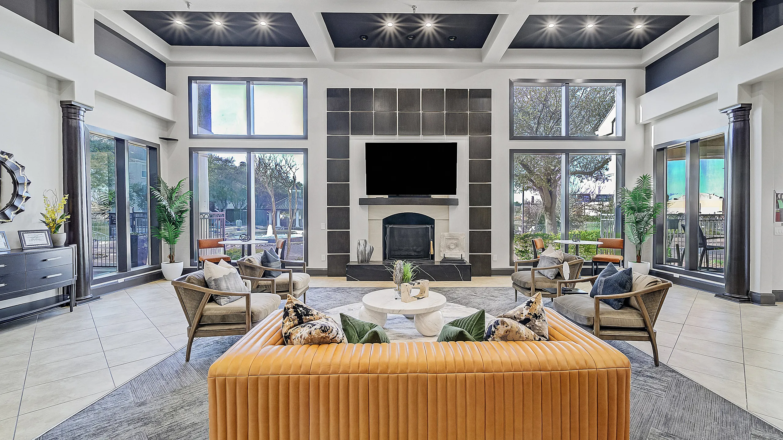 Luxurious modern living room with tall windows, sleek decor, and chic furniture, perfect for relaxation and entertaining.