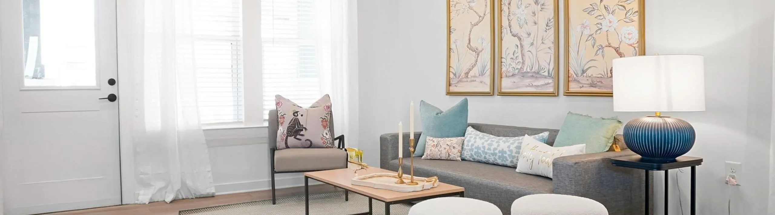 Bright and modern living room with elegant decor, plush sofa, artistic wall art, and cozy accents.