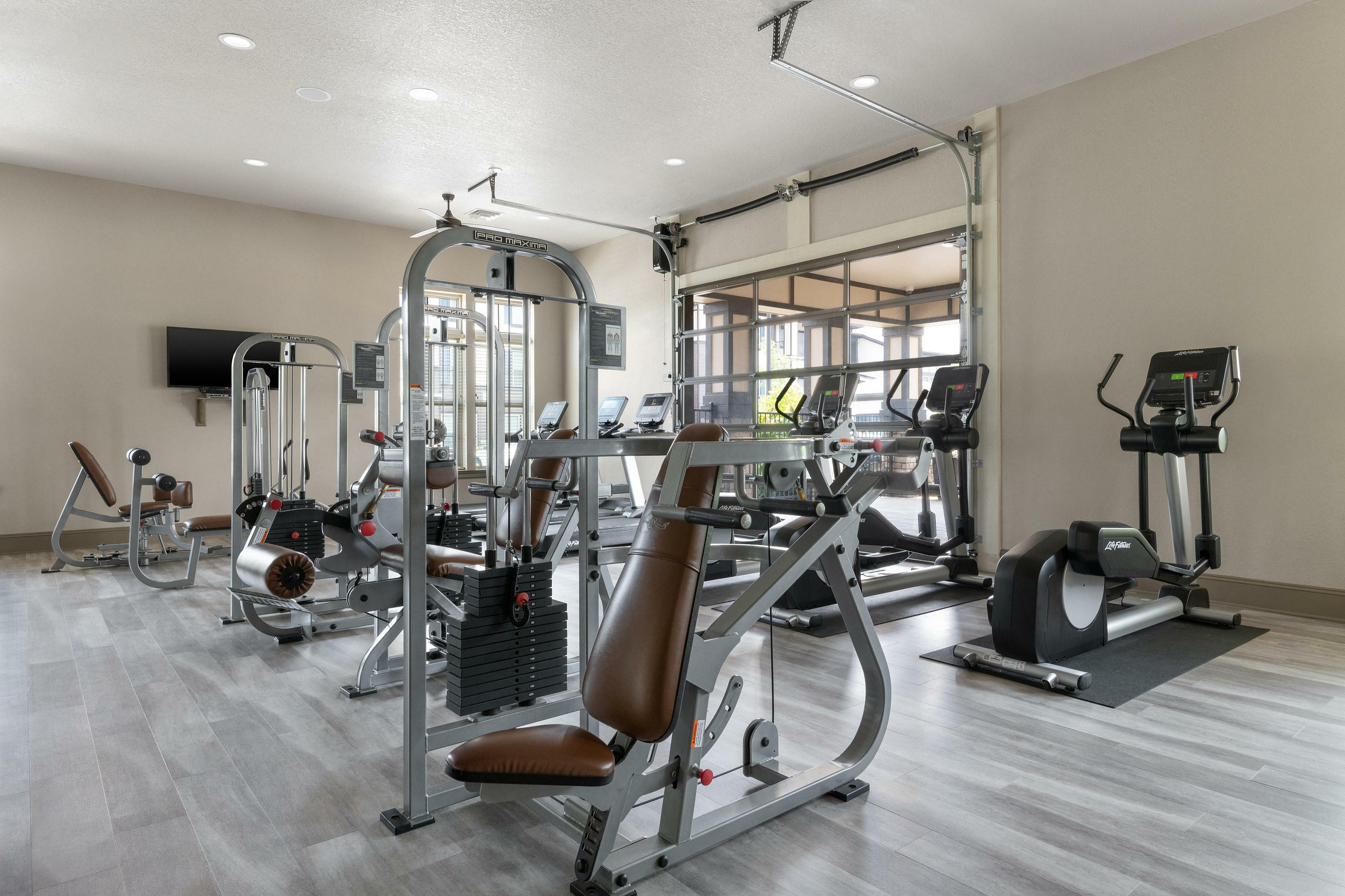 State-of-the-art gym with modern exercise equipment including treadmills and weight machines.