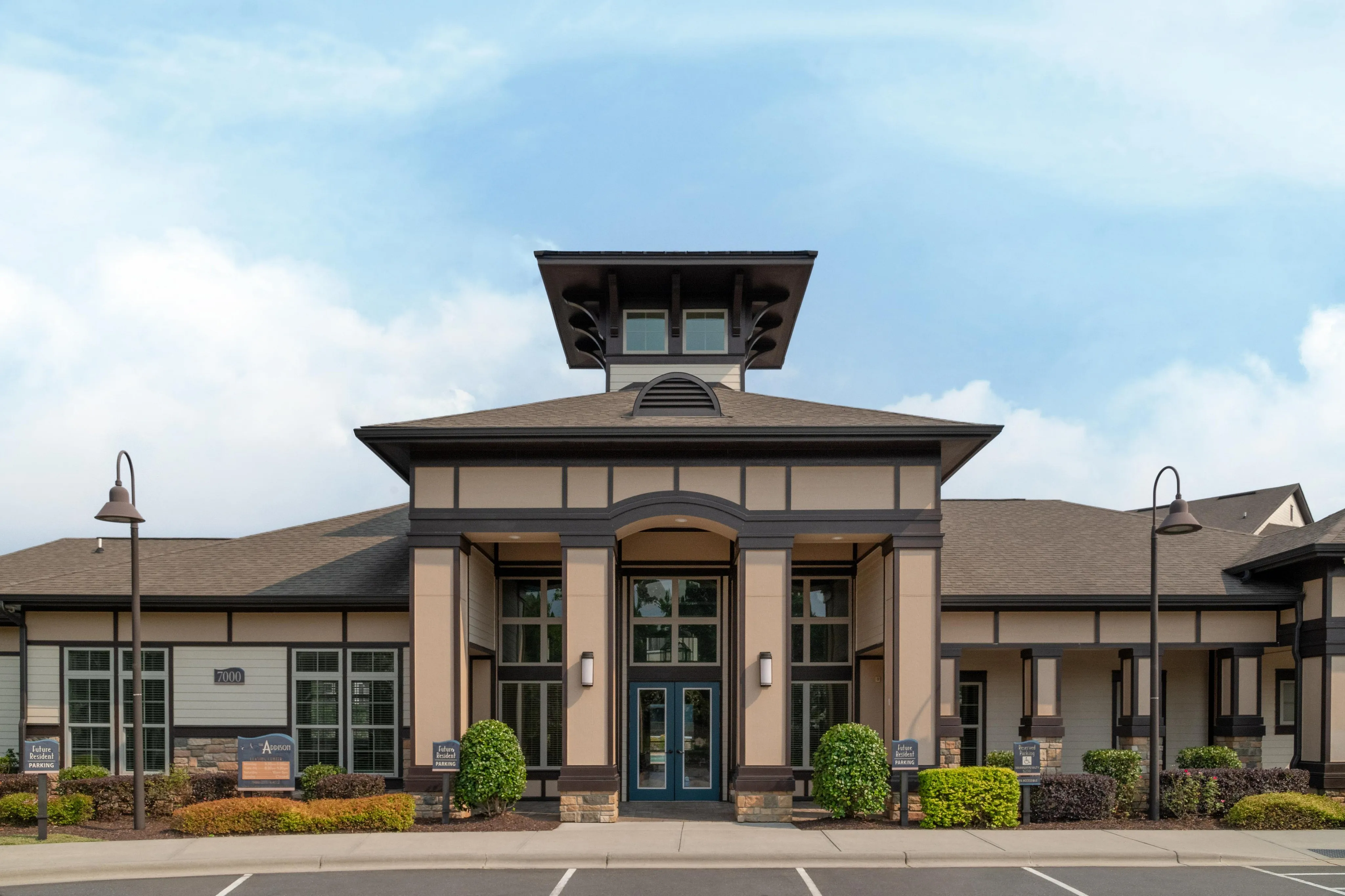 Sophisticated apartment complex with modern architectural design and well-maintained landscaping.