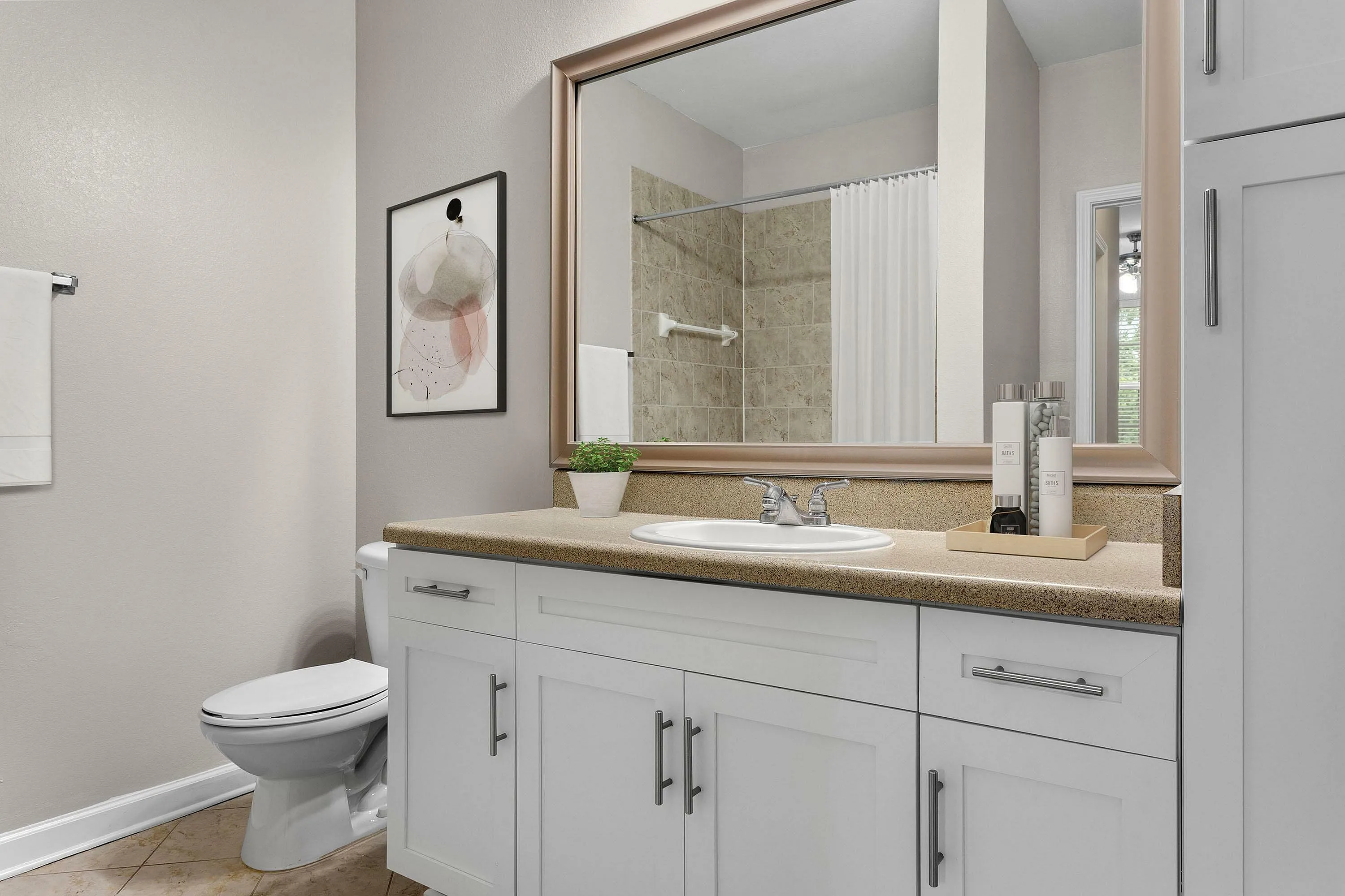 Modern bathroom with sleek vanity, large mirror, and stylish decor elements.