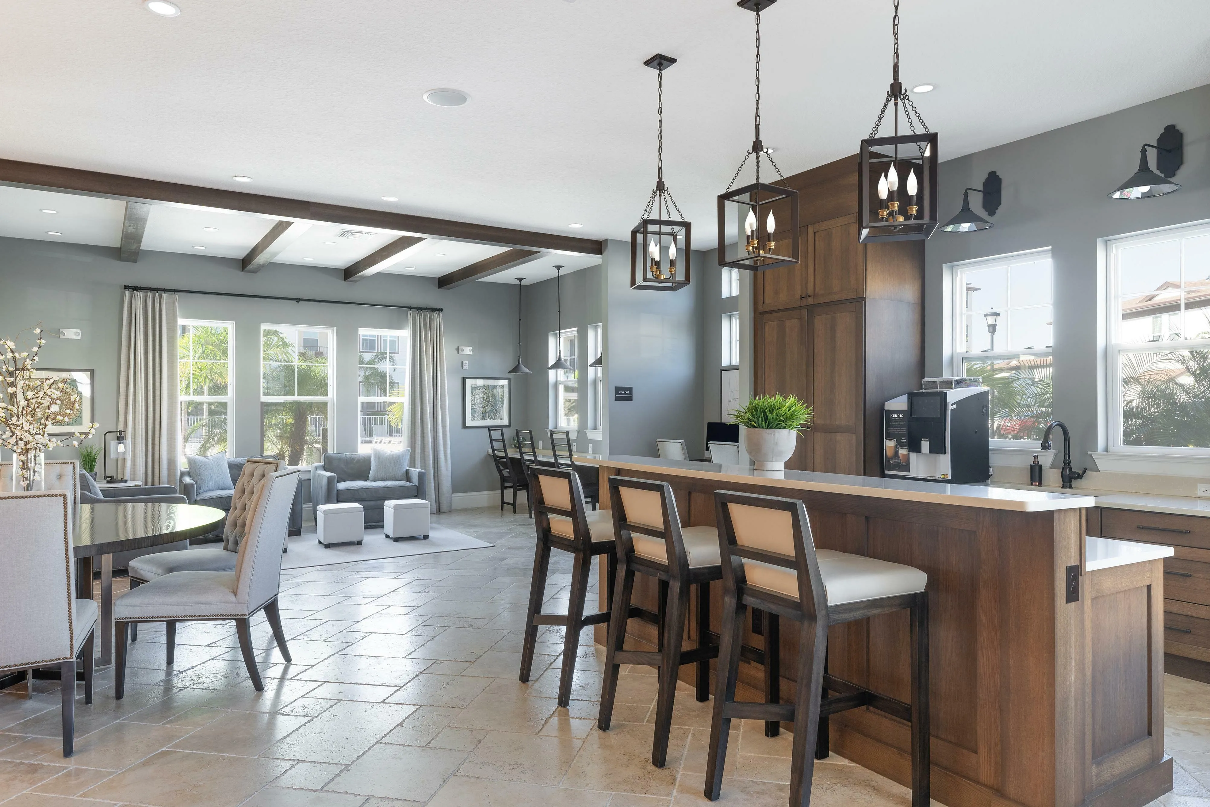 Bright and airy open-concept living area with stylish modern furniture and kitchen bar seating.