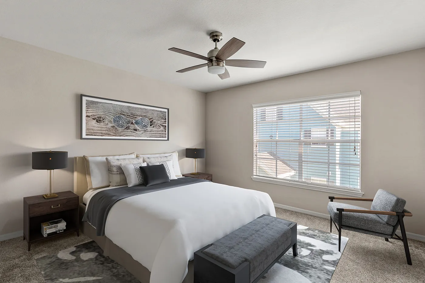 Elegant bedroom with modern decor, featuring a plush bed, sleek lamps, and a cozy seating area. Natural light flows through large windows, creating a serene atmosphere.